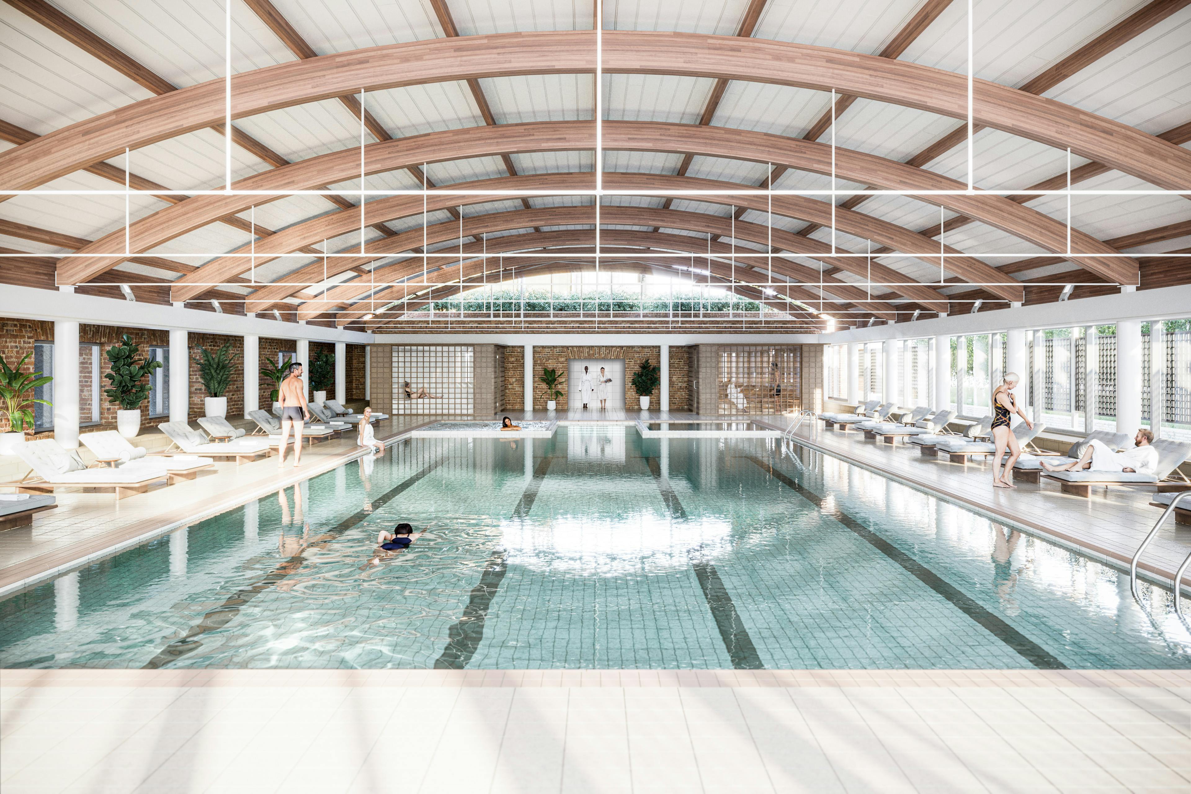 Caption: a large indoor swimming pool with people in it