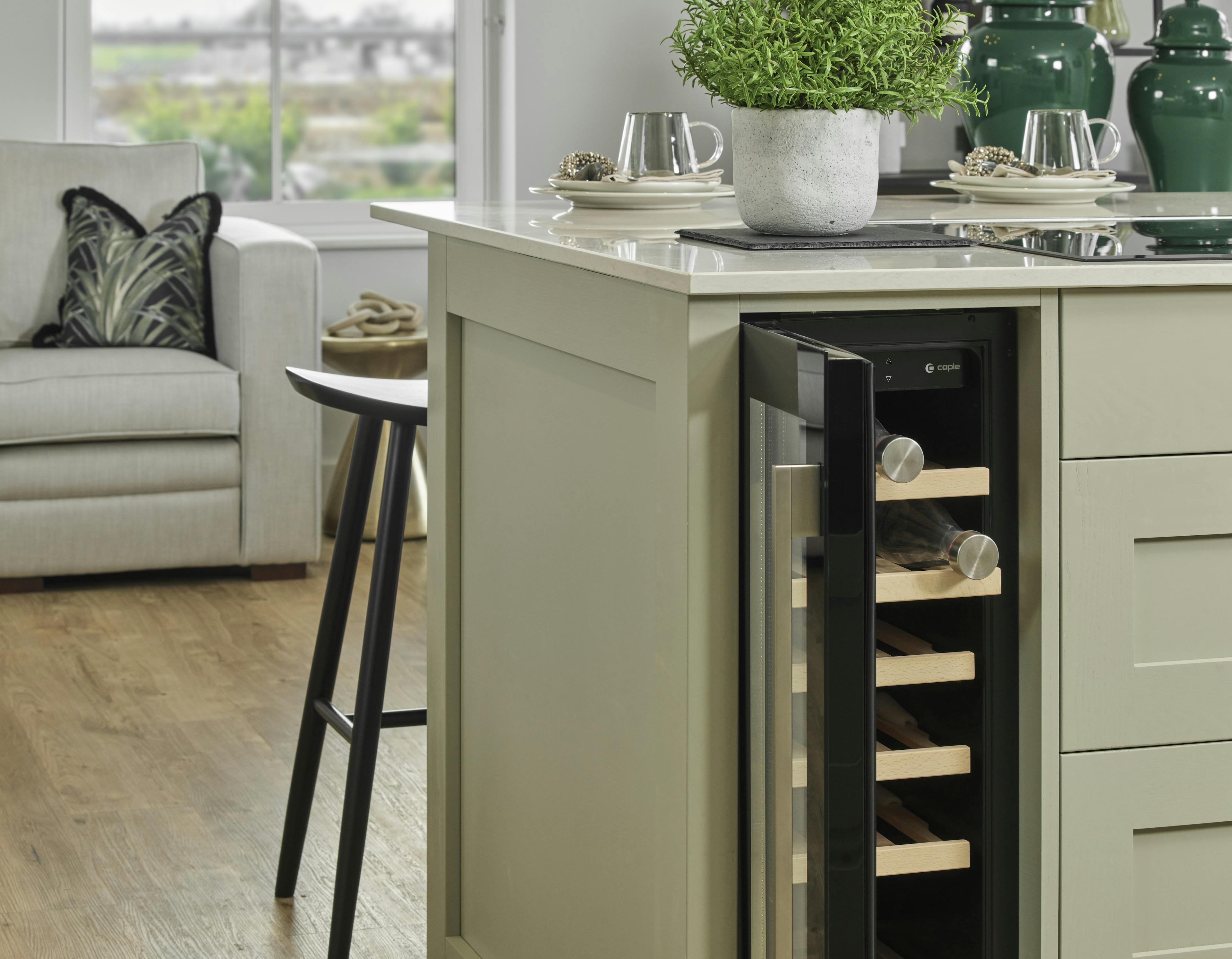 Caption: a kitchen island with a wine rack in it