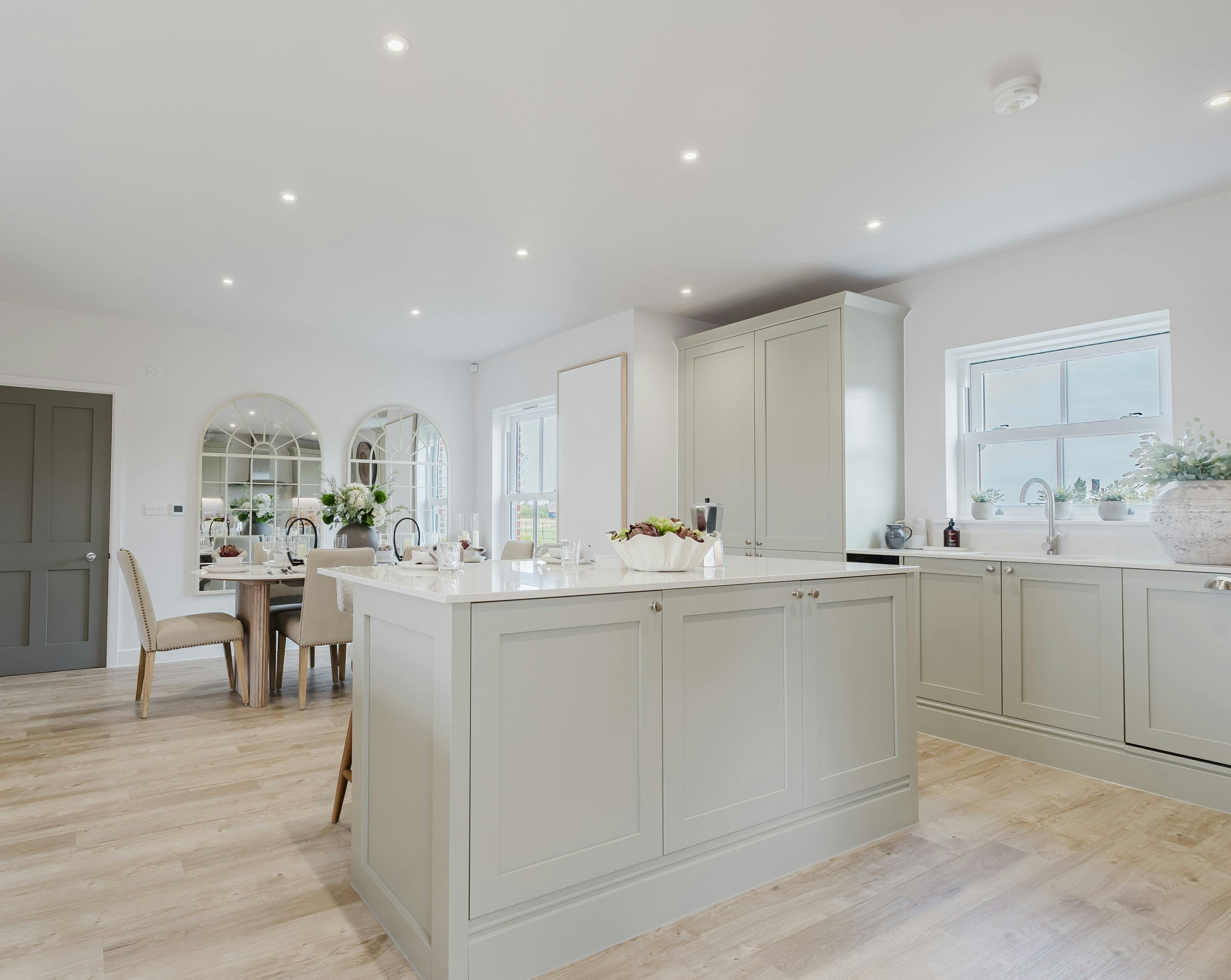 Caption: a large kitchen with a center island in the middle of the room