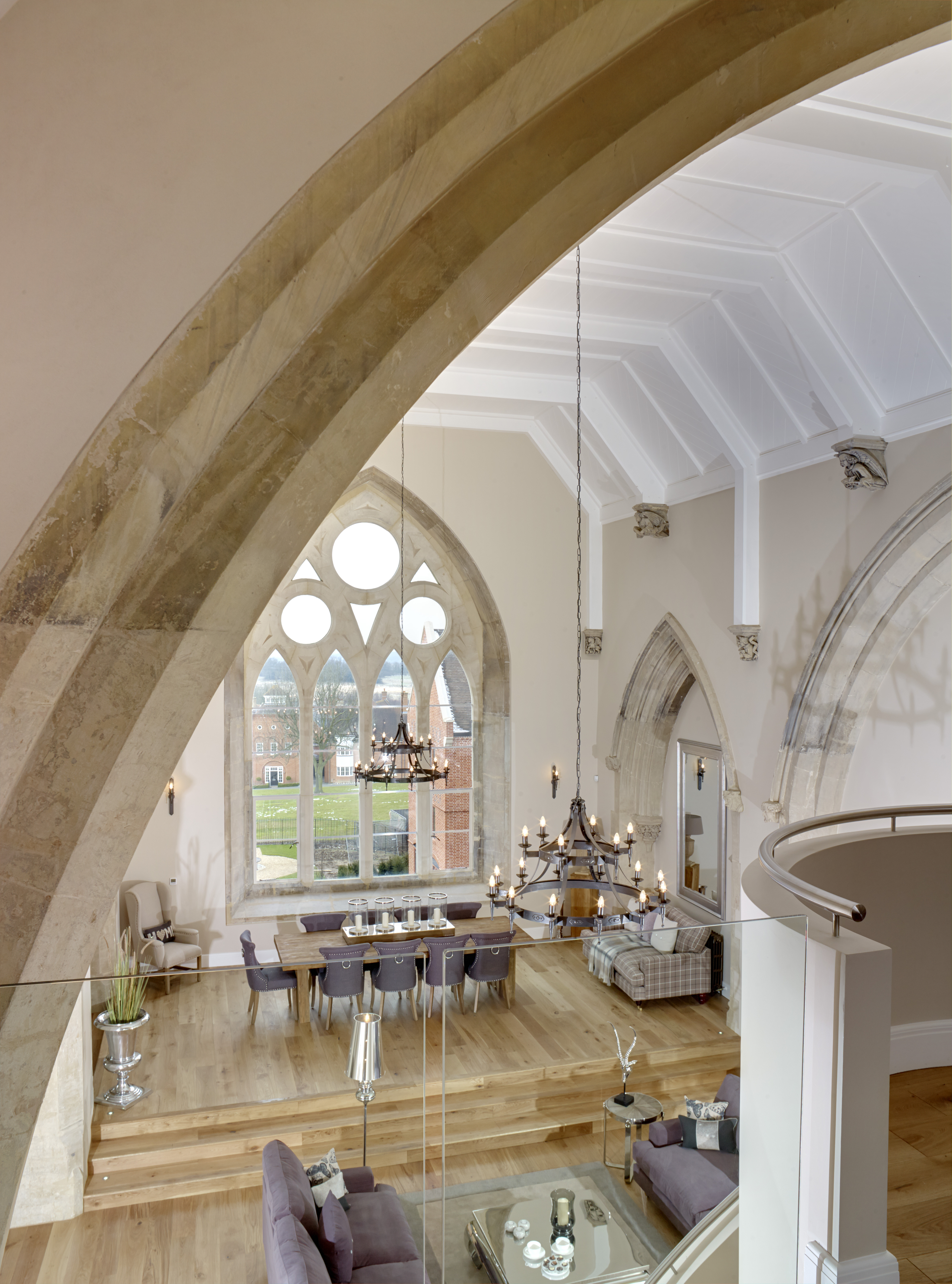 Caption: a large living room with a large arched window