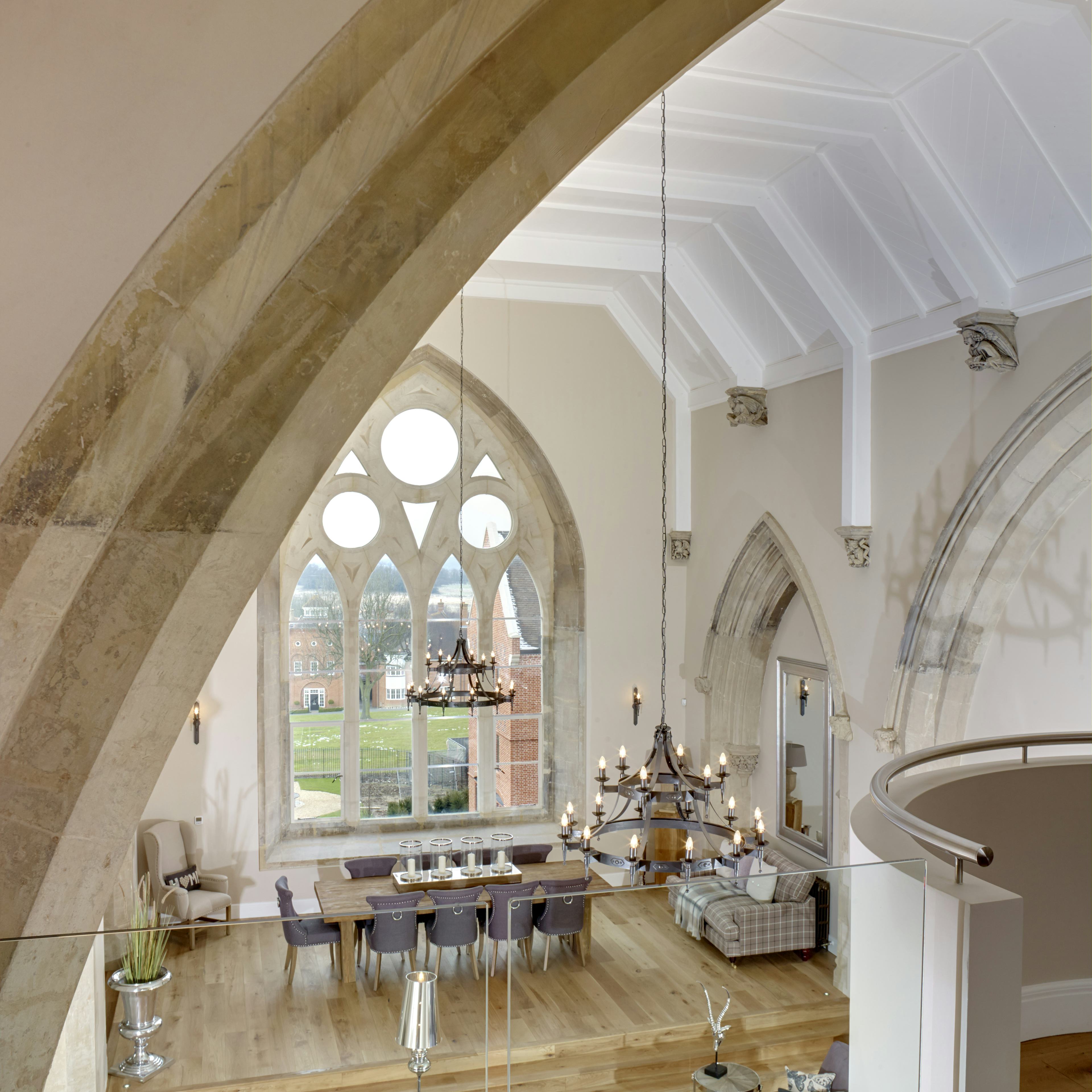 Caption: a large living room with a large arched window