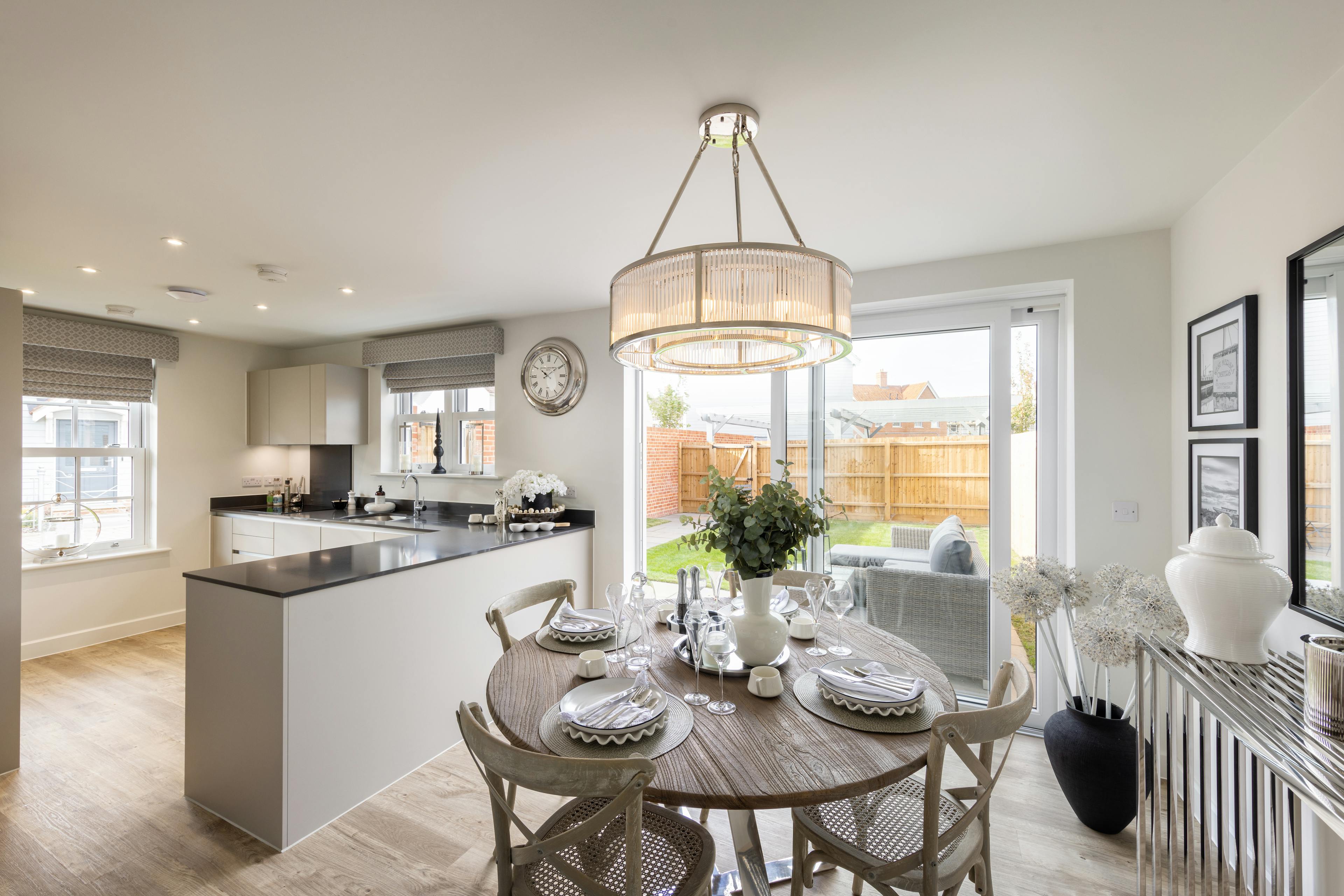 Caption: a kitchen and dining room with a table and chairs