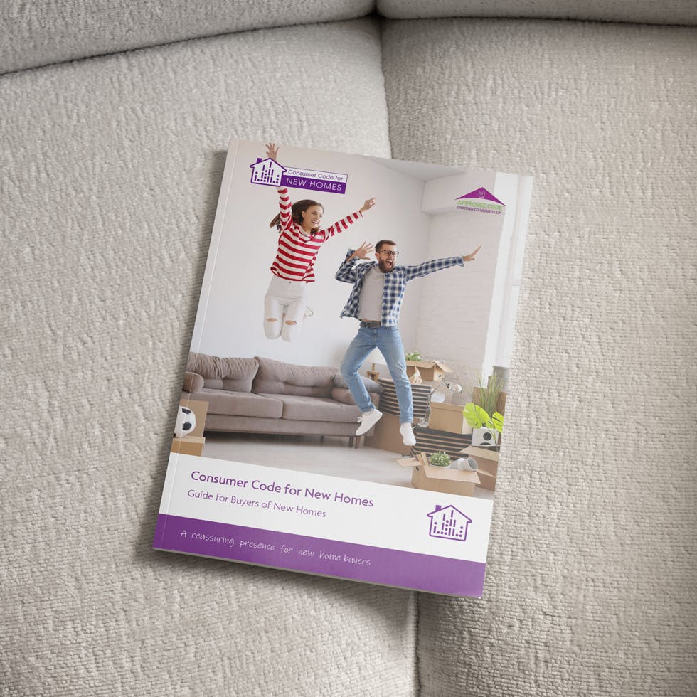 Consumer Code Booklet on a sofa