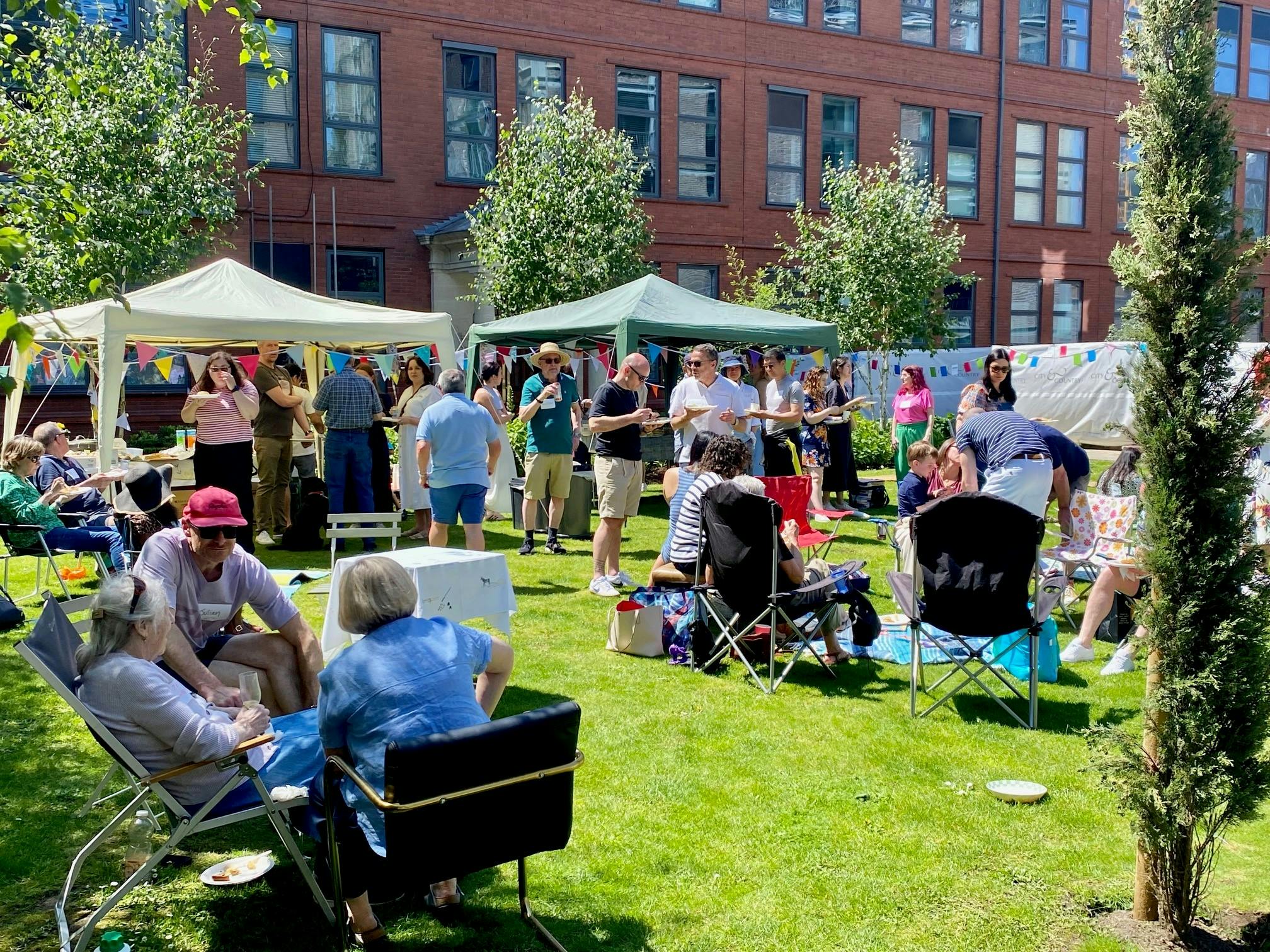 Caption: a group of people sitting in lawn chairs in front of a building