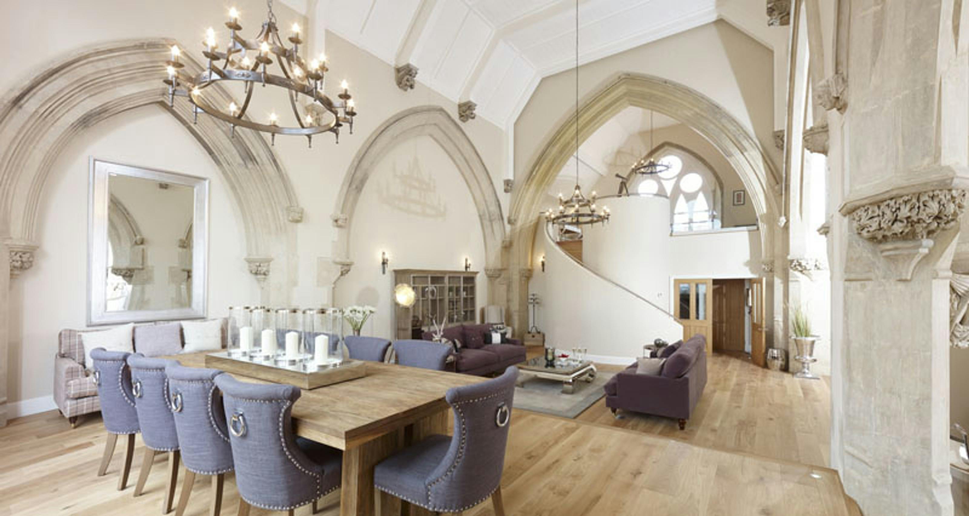 Caption: a dining room with a wooden table surrounded by blue chairs