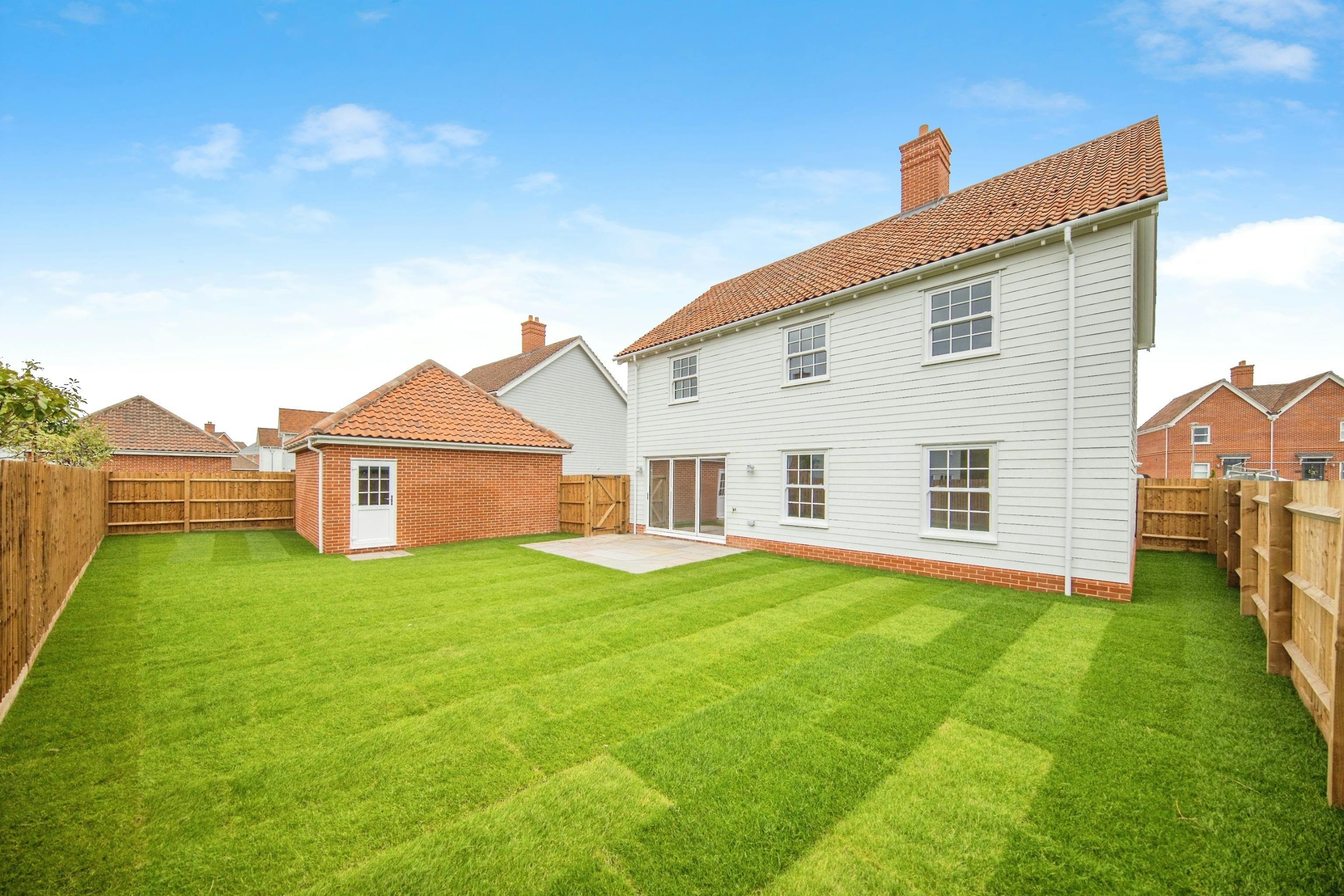 Caption: a white house with a green lawn in front of it