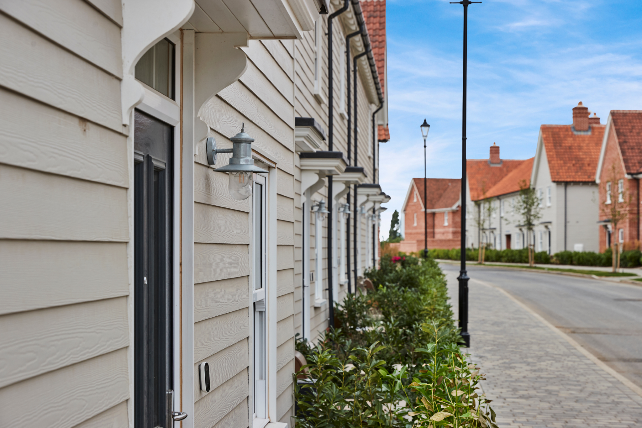 Caption: a row of houses along a street with a street light