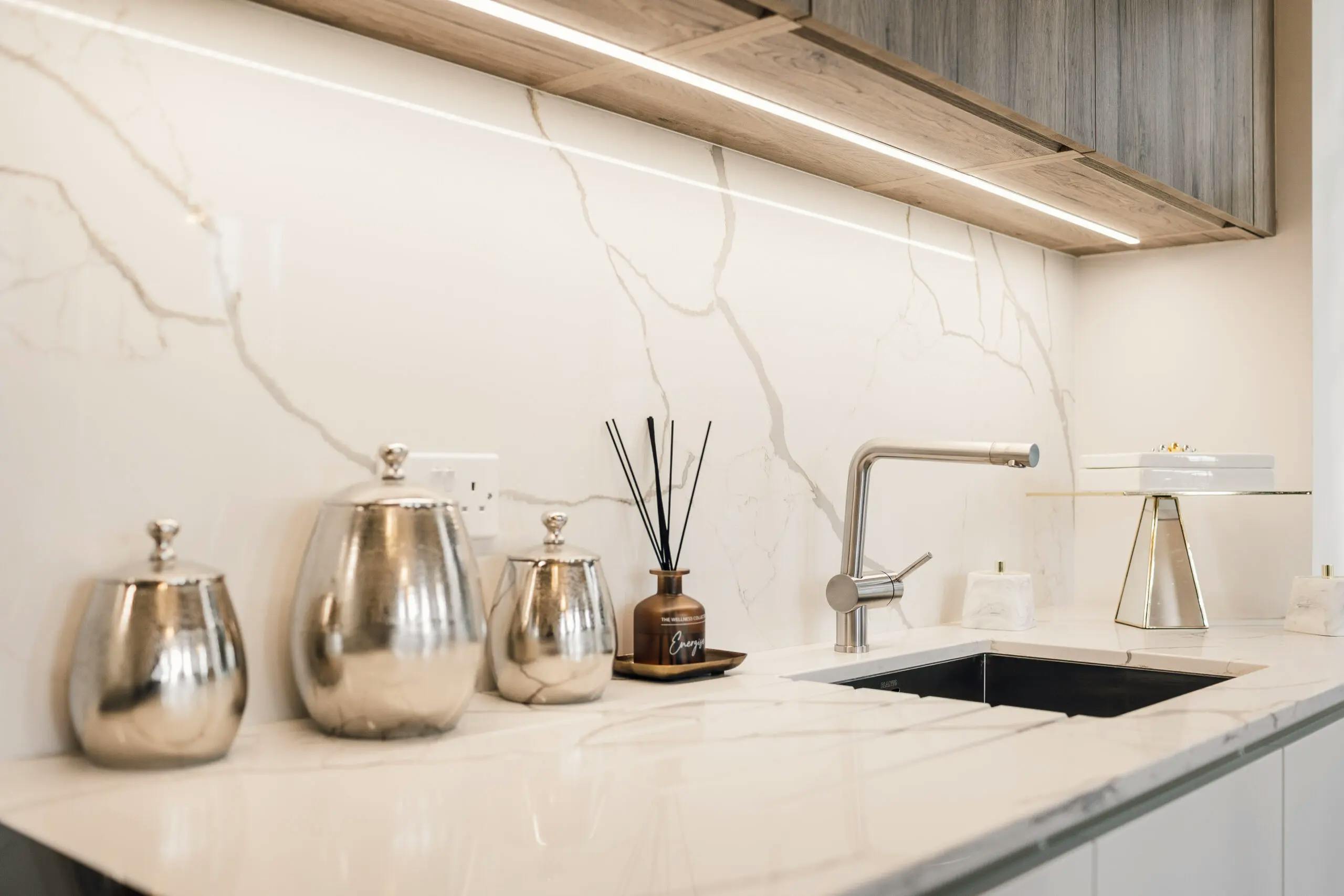 Caption: a kitchen with marble counter tops and a sink
