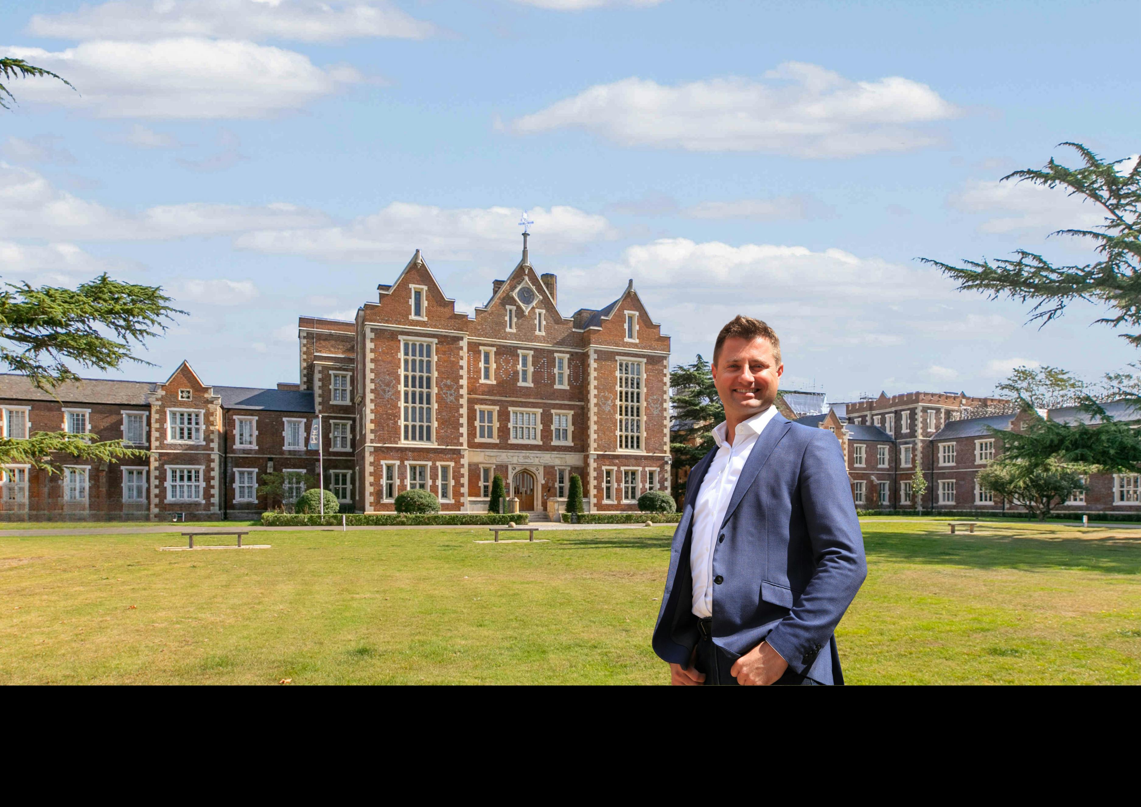 Caption: a man standing in front of a large building