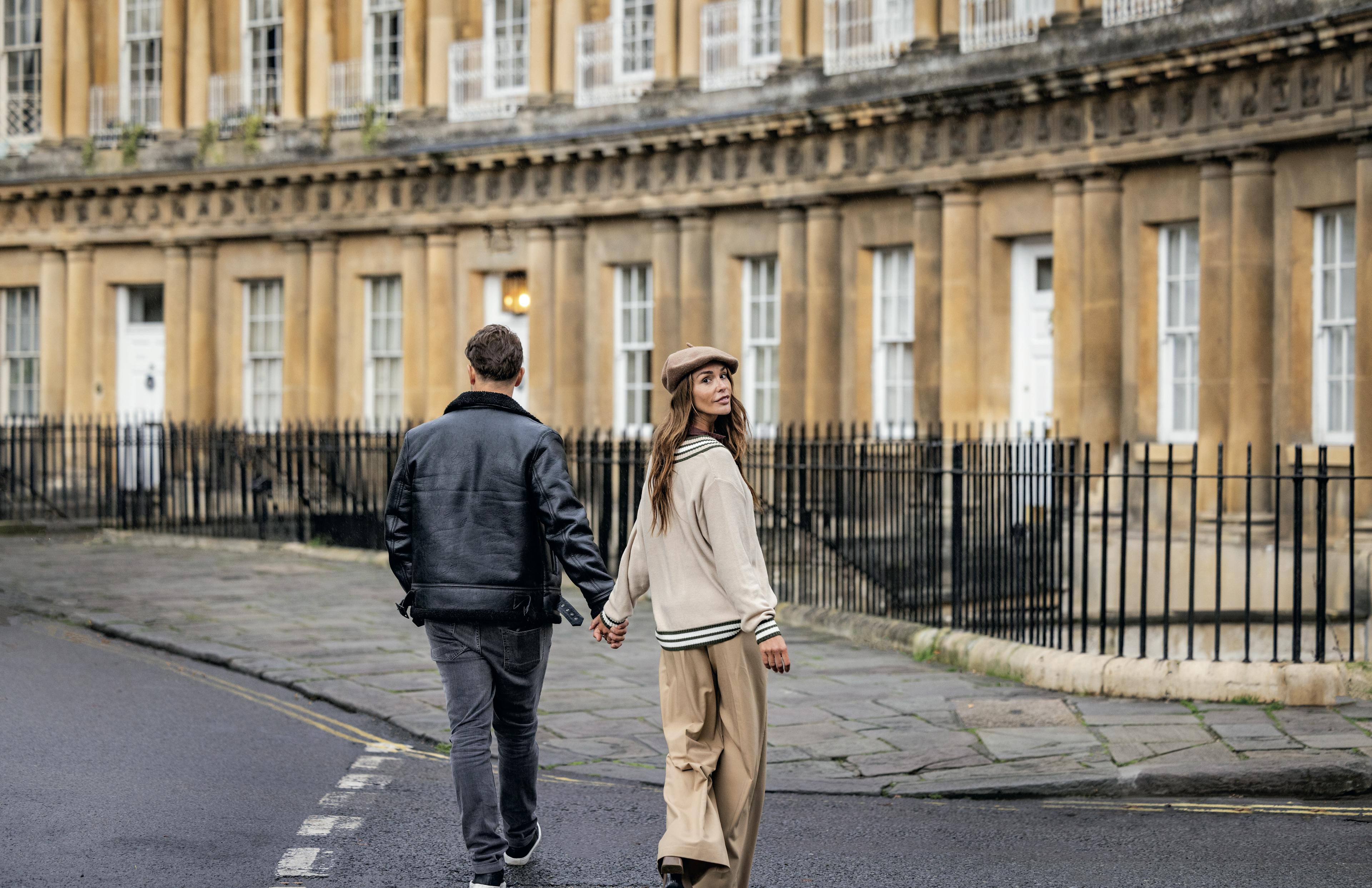 Caption: a man and a woman walking down a street