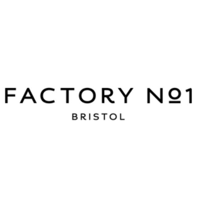 Caption: a black and white photo of the factory logo