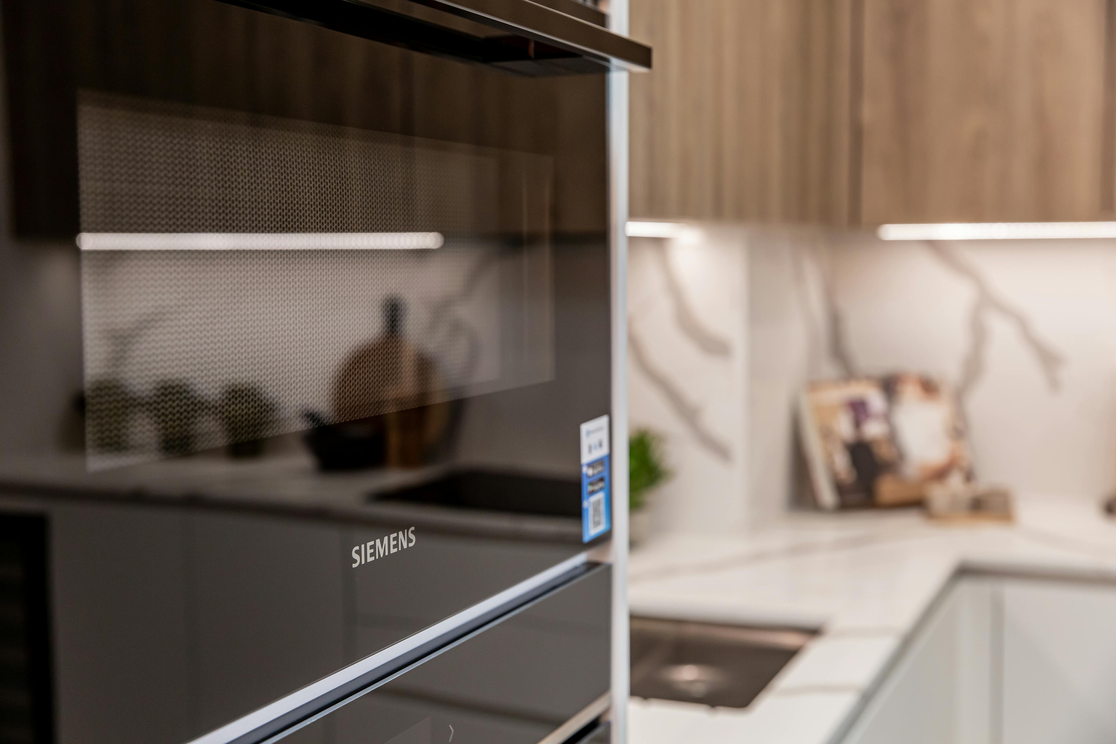 Caption: a close up of a microwave oven in a kitchen