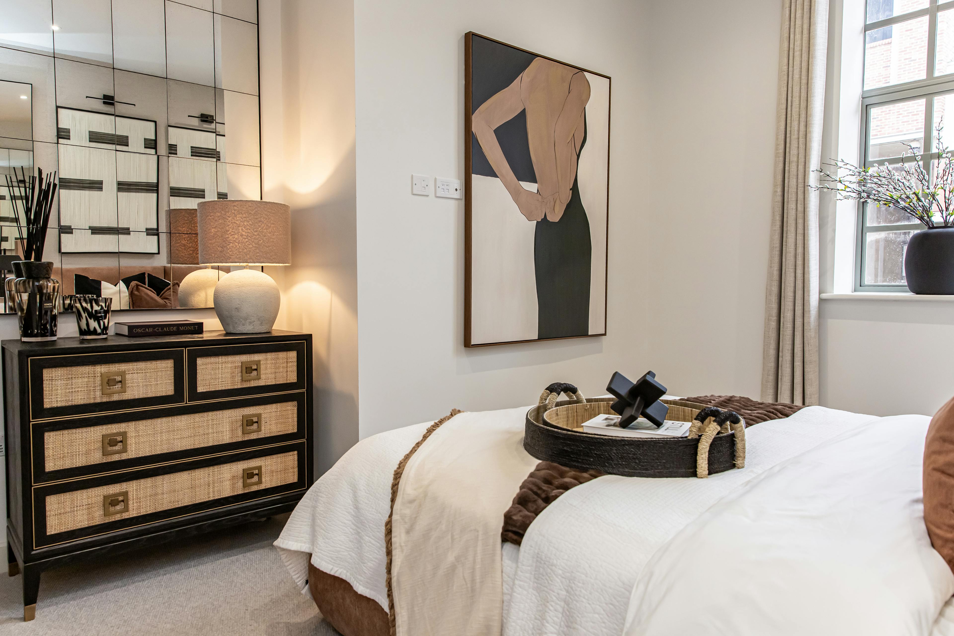 Caption: a bedroom with a bed, dresser and mirror