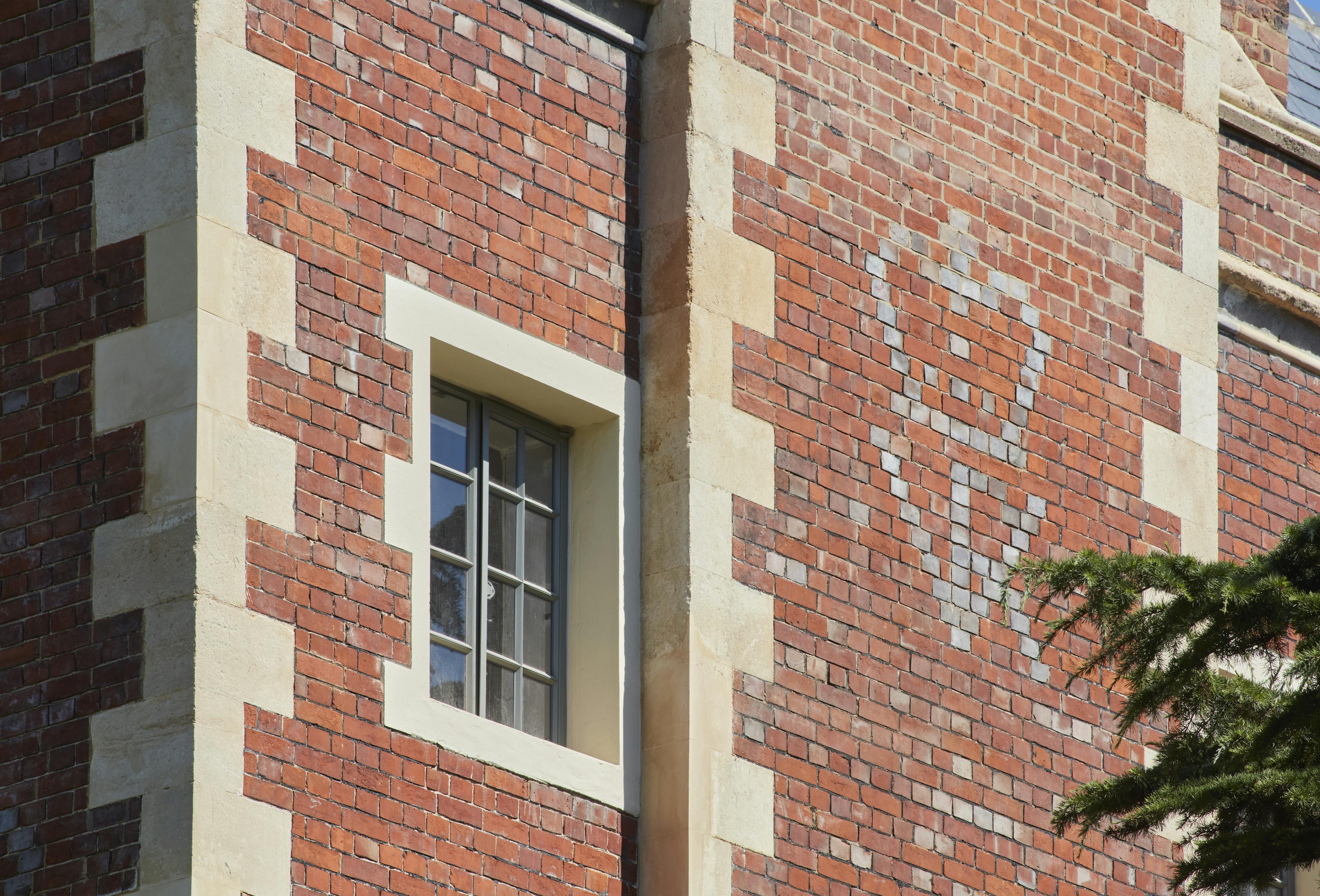 Caption: a red brick building with a white window