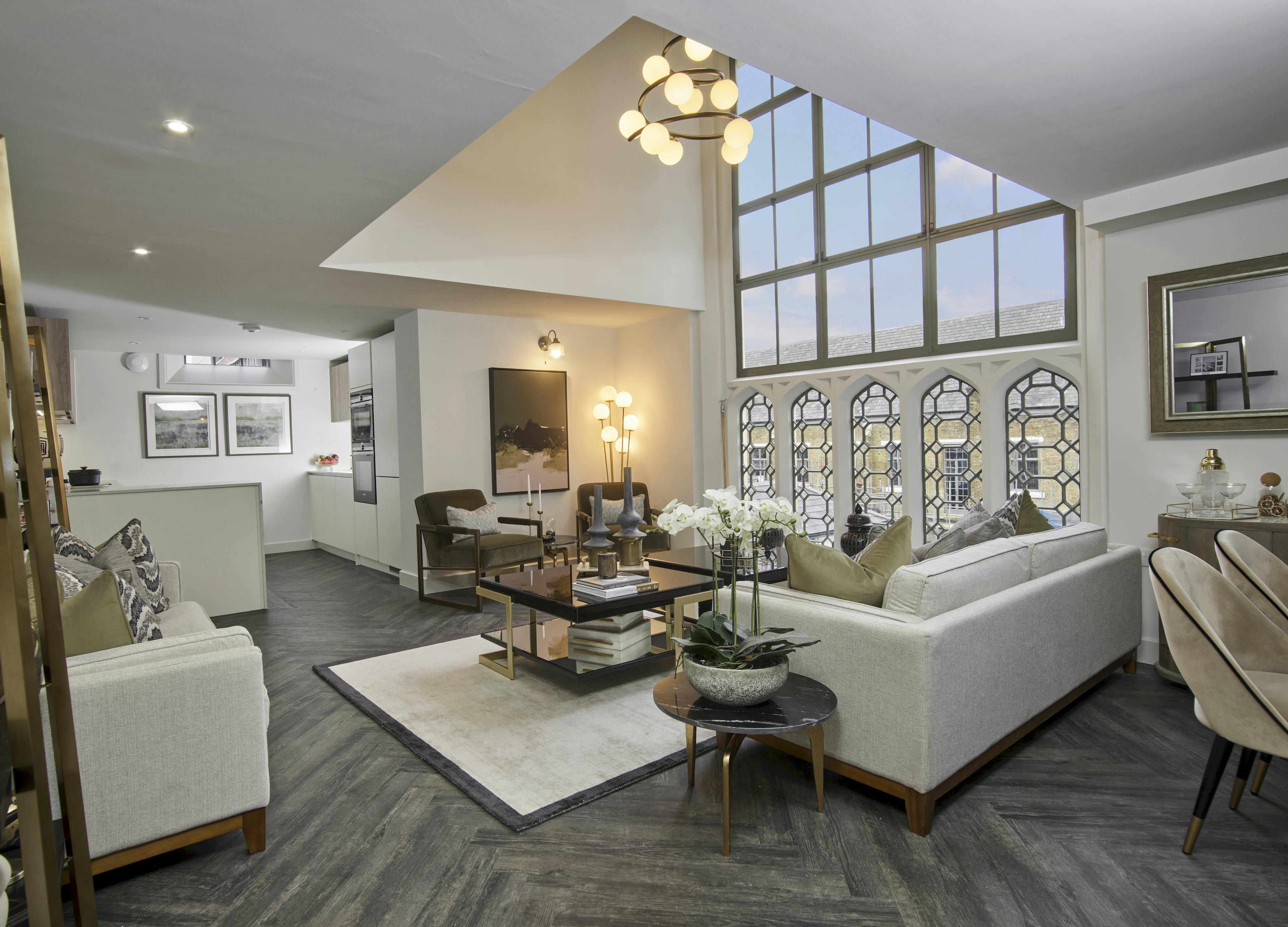 Caption: a living room filled with furniture and a large window