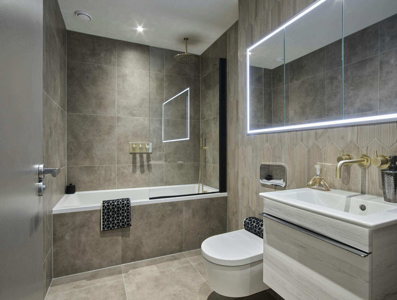 Caption: a bathroom with a toilet, sink, mirror and bathtub