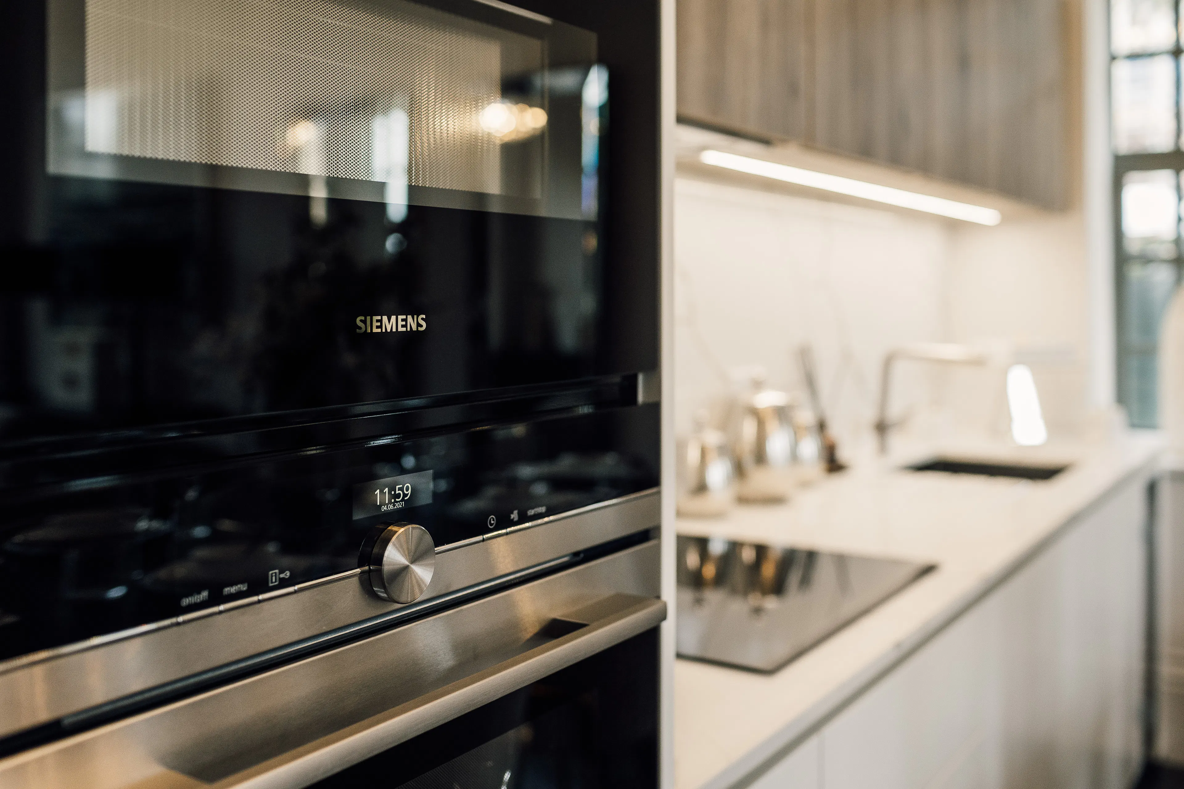 Caption: a stainless steel oven and sink in a kitchen
