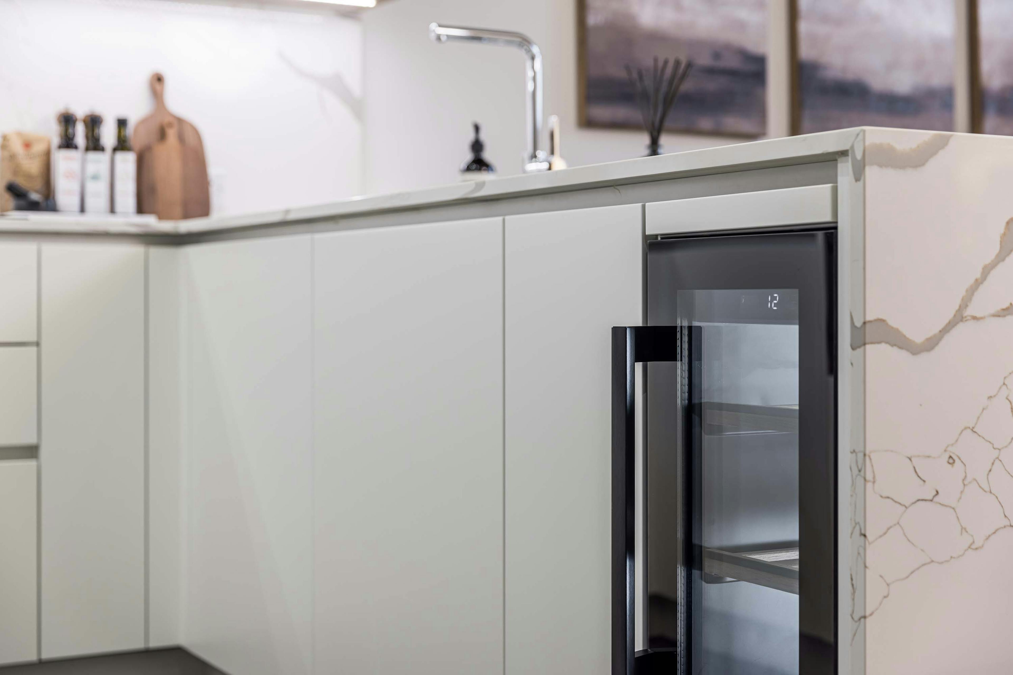 Caption: a kitchen with a refrigerator and a sink