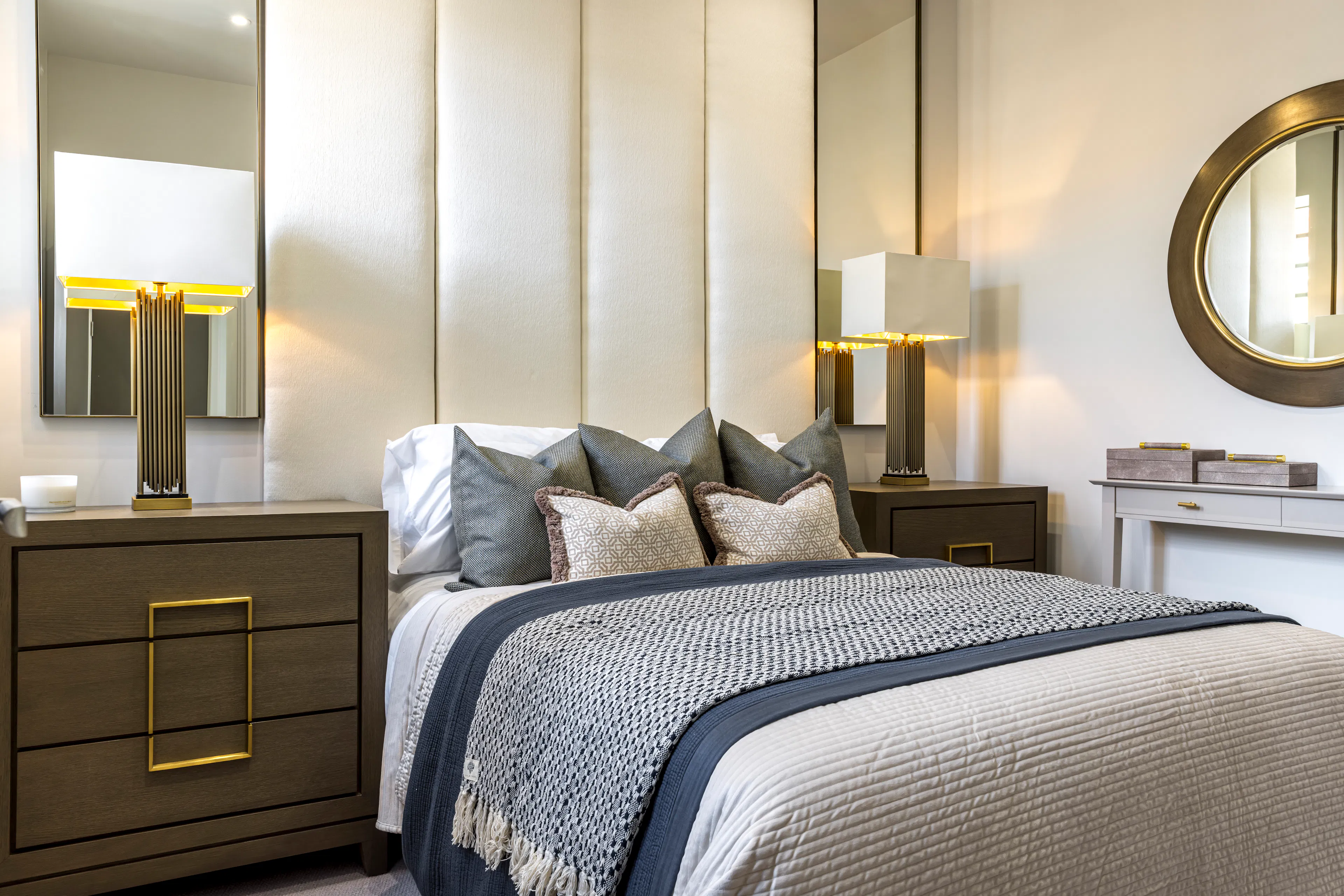Caption: a bedroom with a bed, dresser and mirror