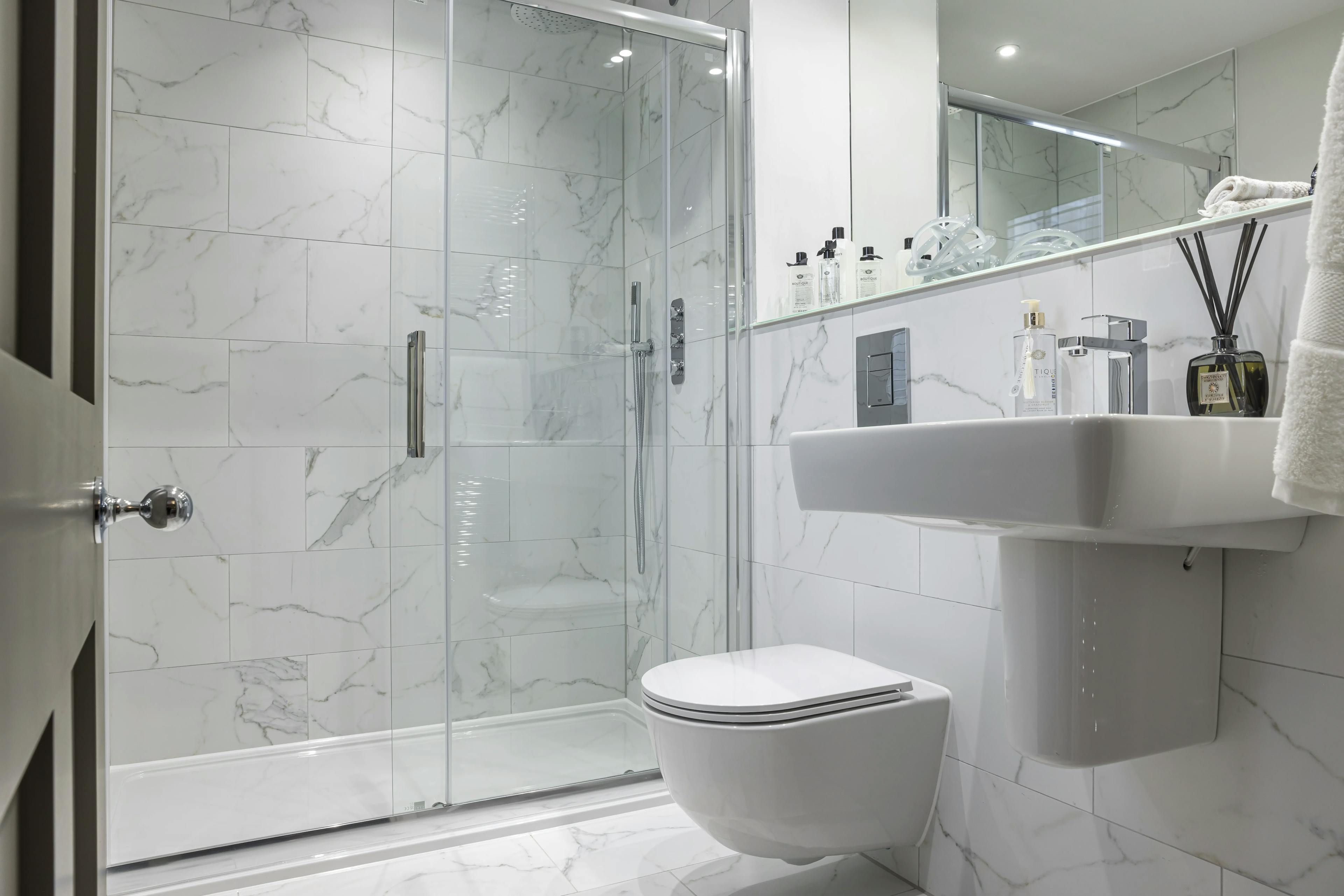 Caption: a bathroom with a toilet, sink, and shower