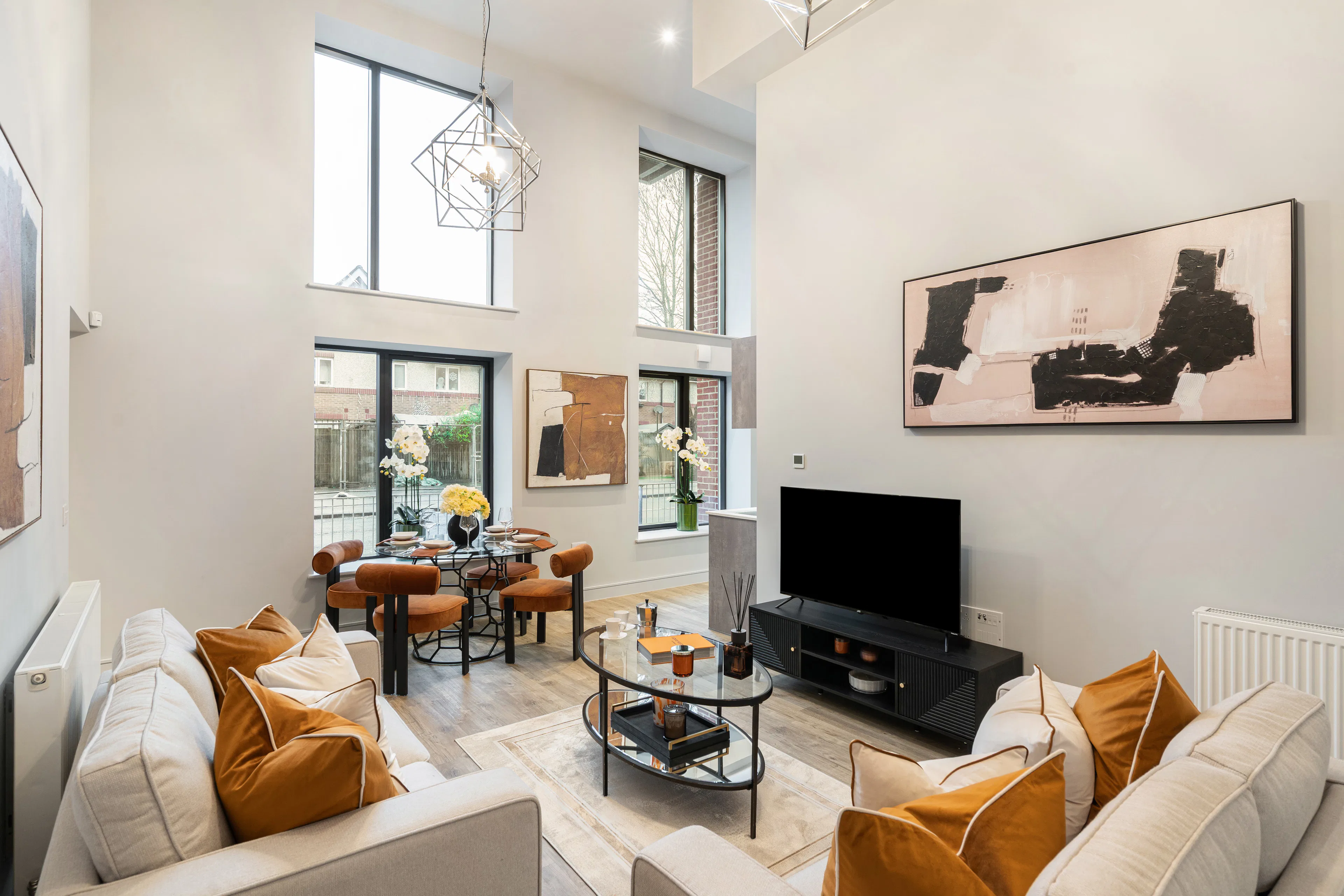 Caption: a living room filled with furniture and a flat screen tv