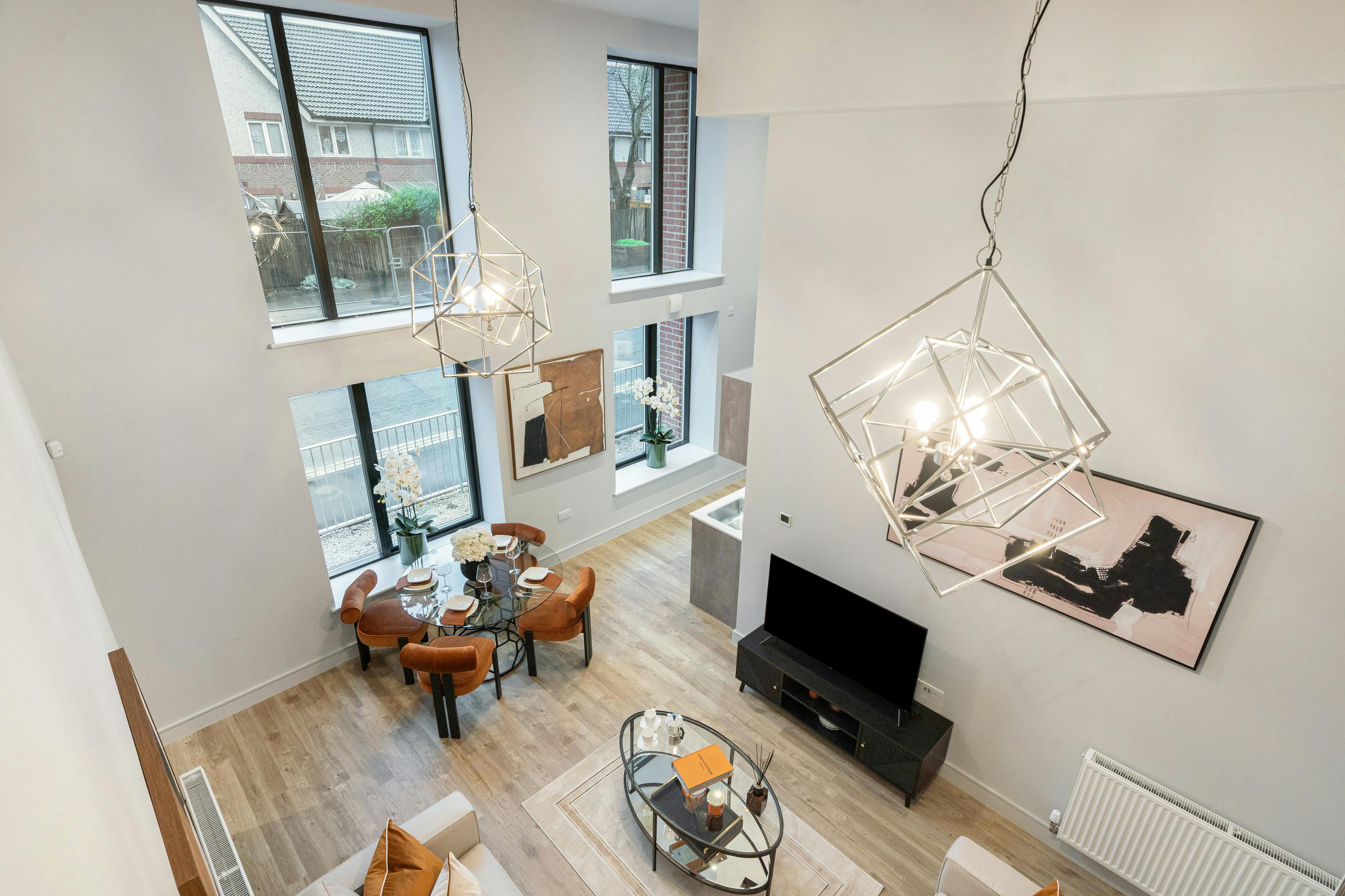 Caption: a living room filled with furniture and a flat screen tv