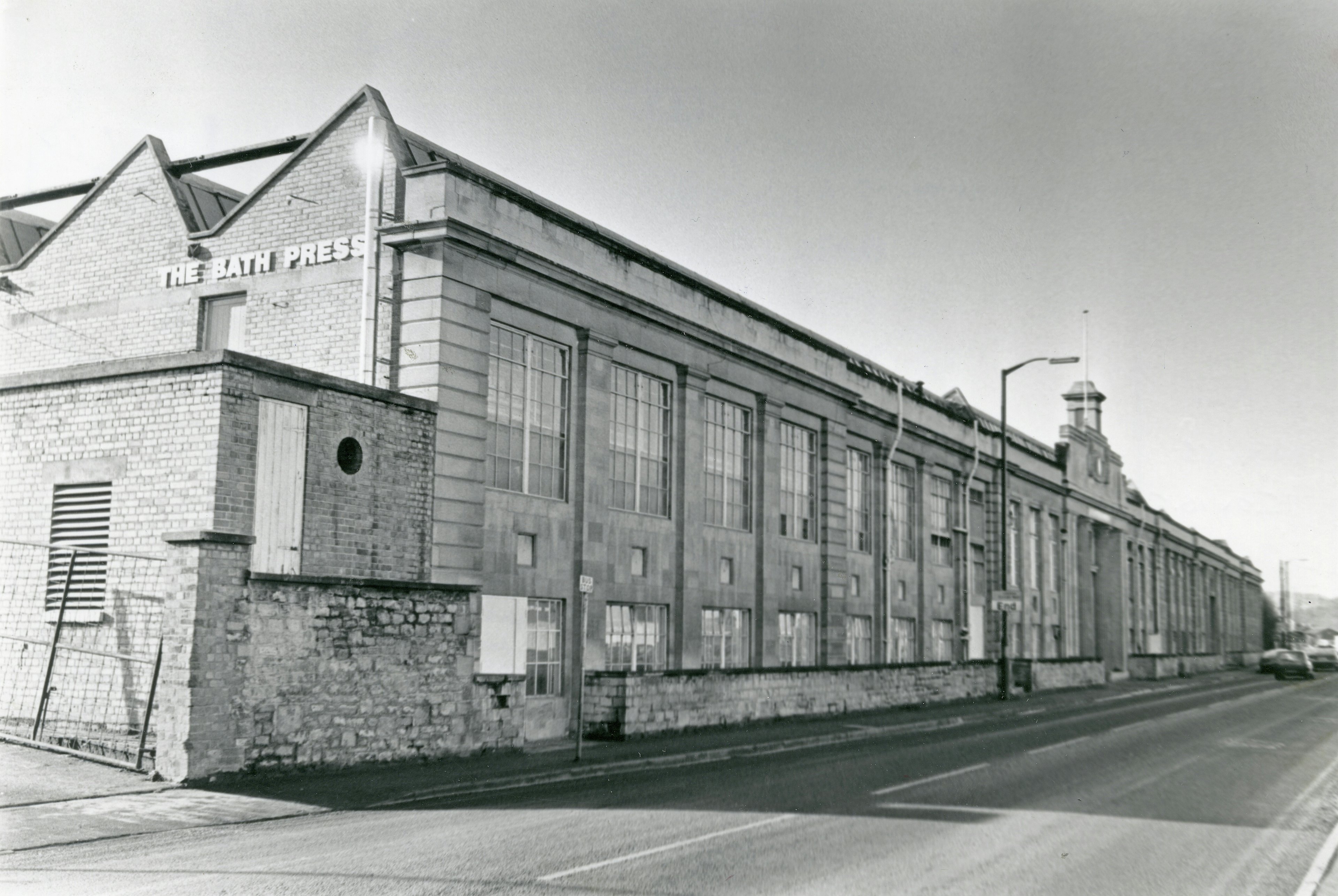 Caption: a black and white photo of a brick building
