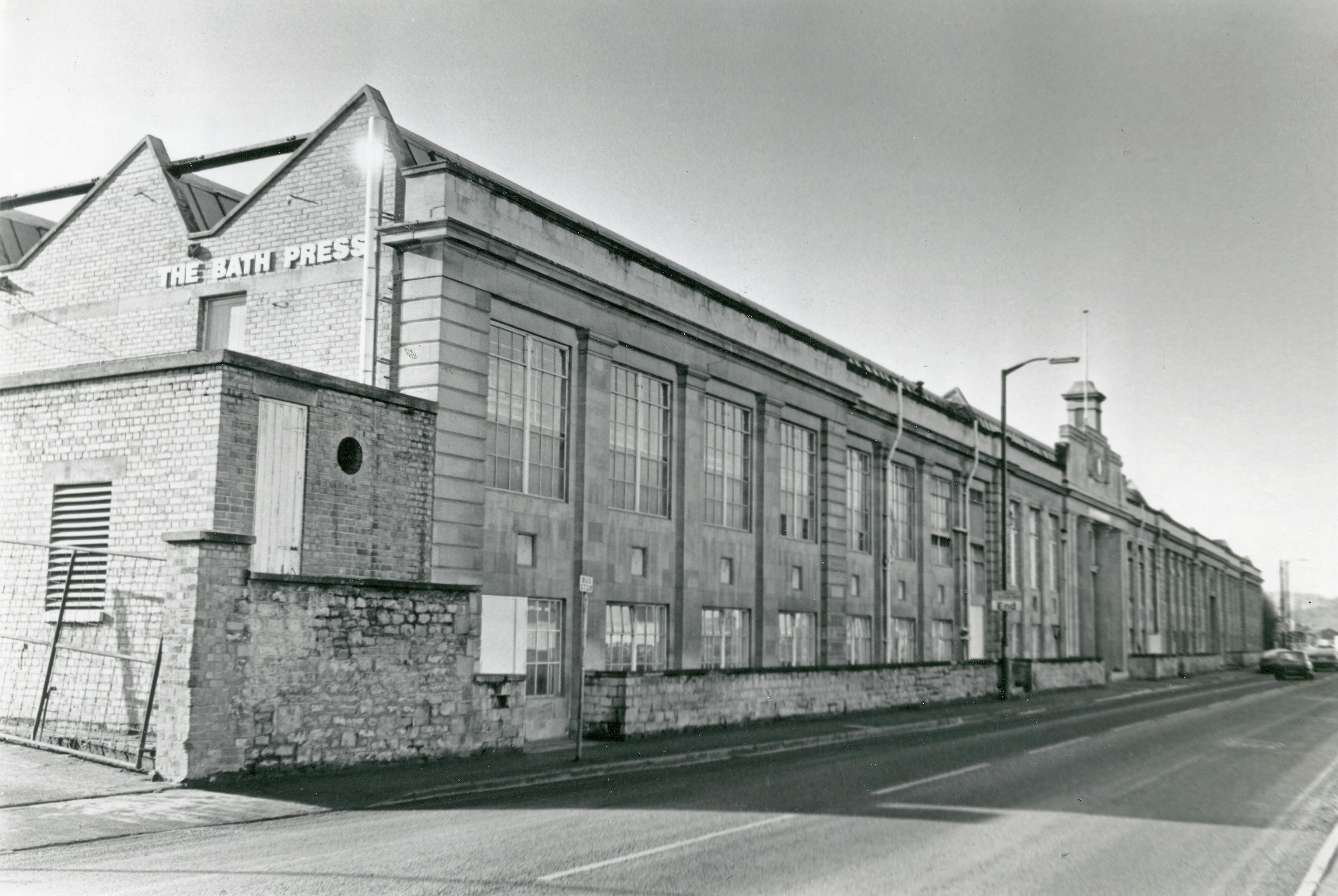 Caption: a black and white photo of a brick building