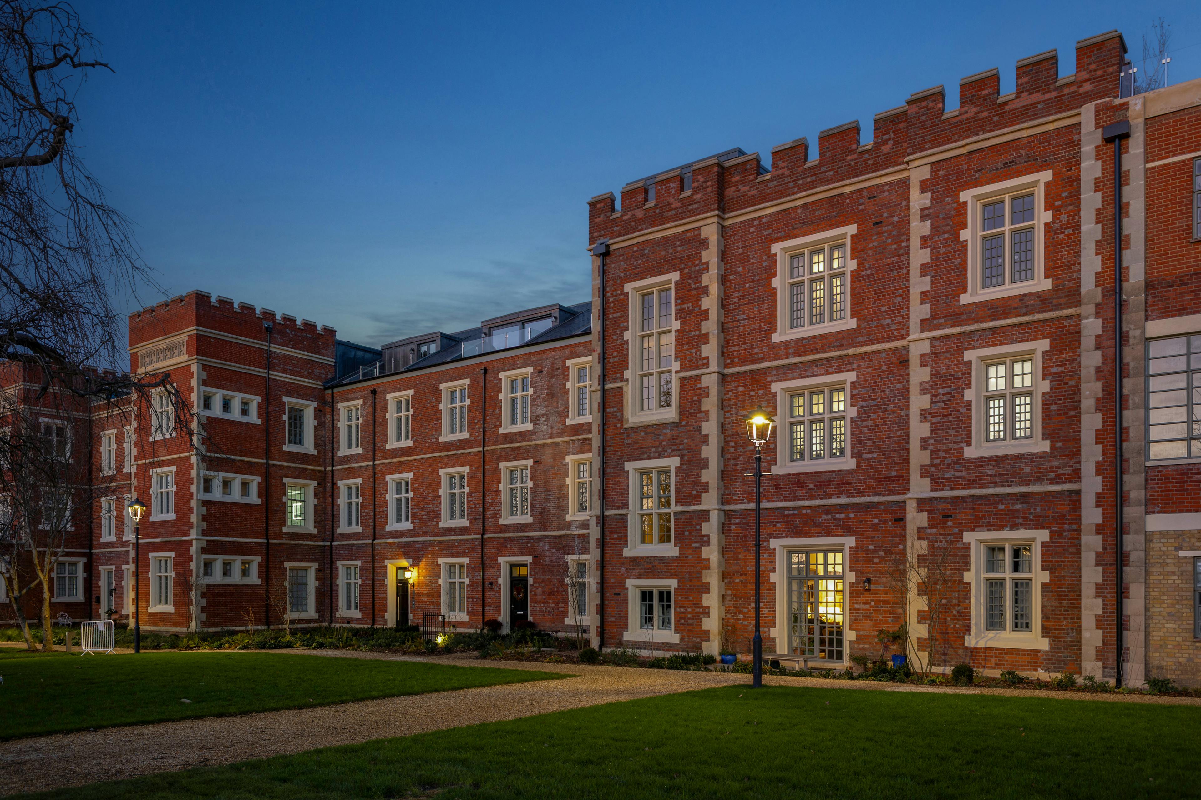 Caption: a large brick building lit up at night