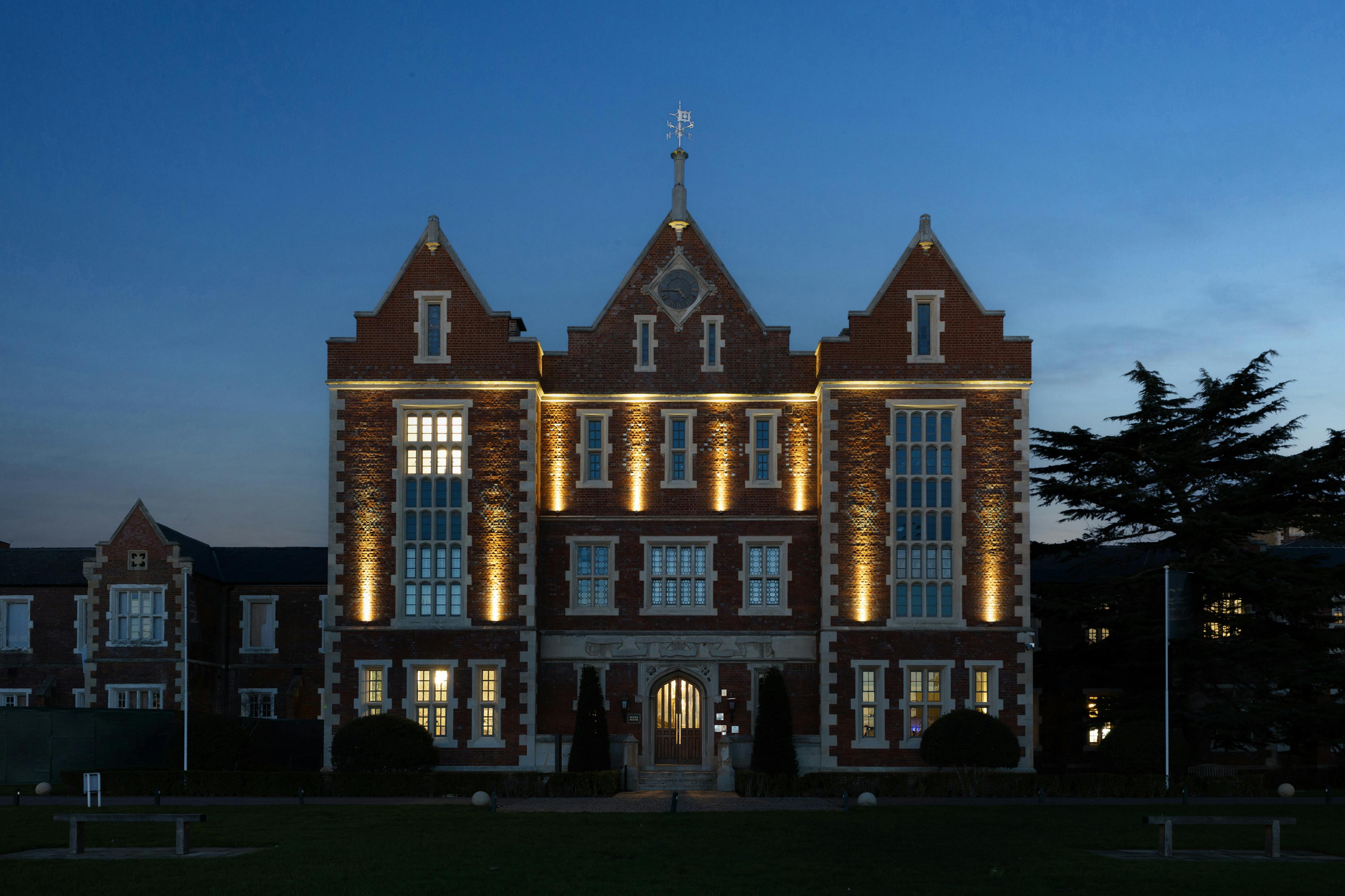 Caption: a large brick building lit up at night