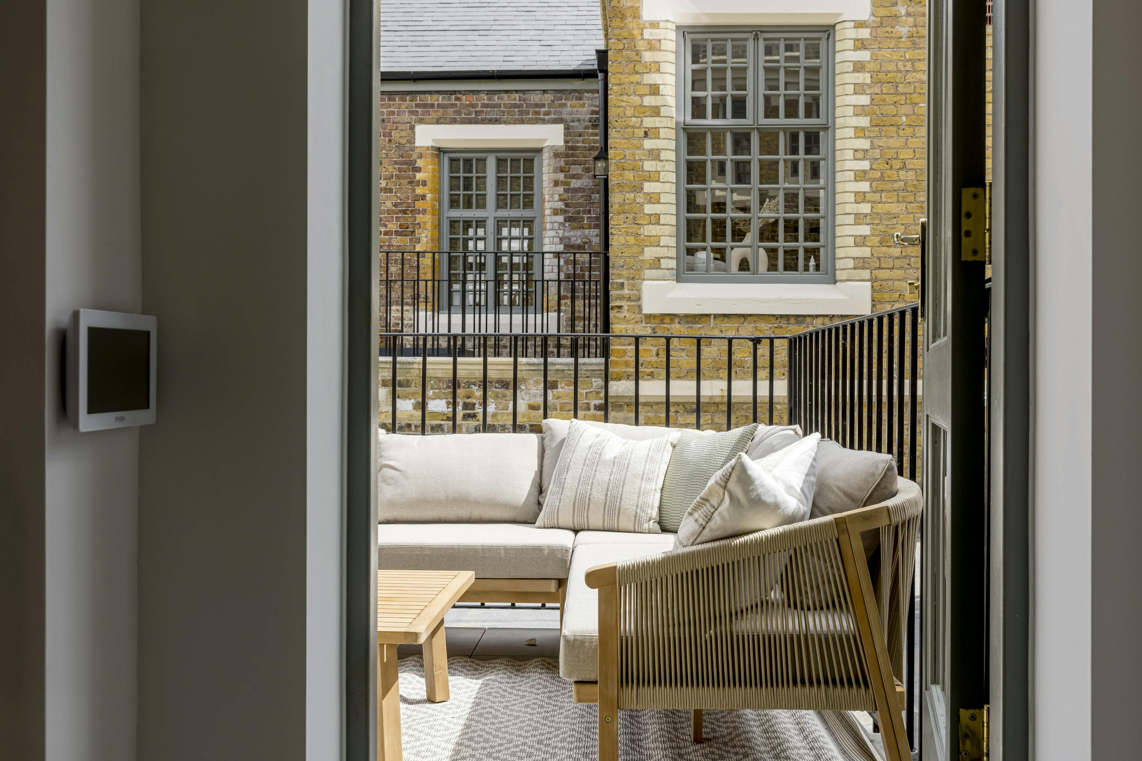 Caption: a living room with a white couch and a wooden coffee table