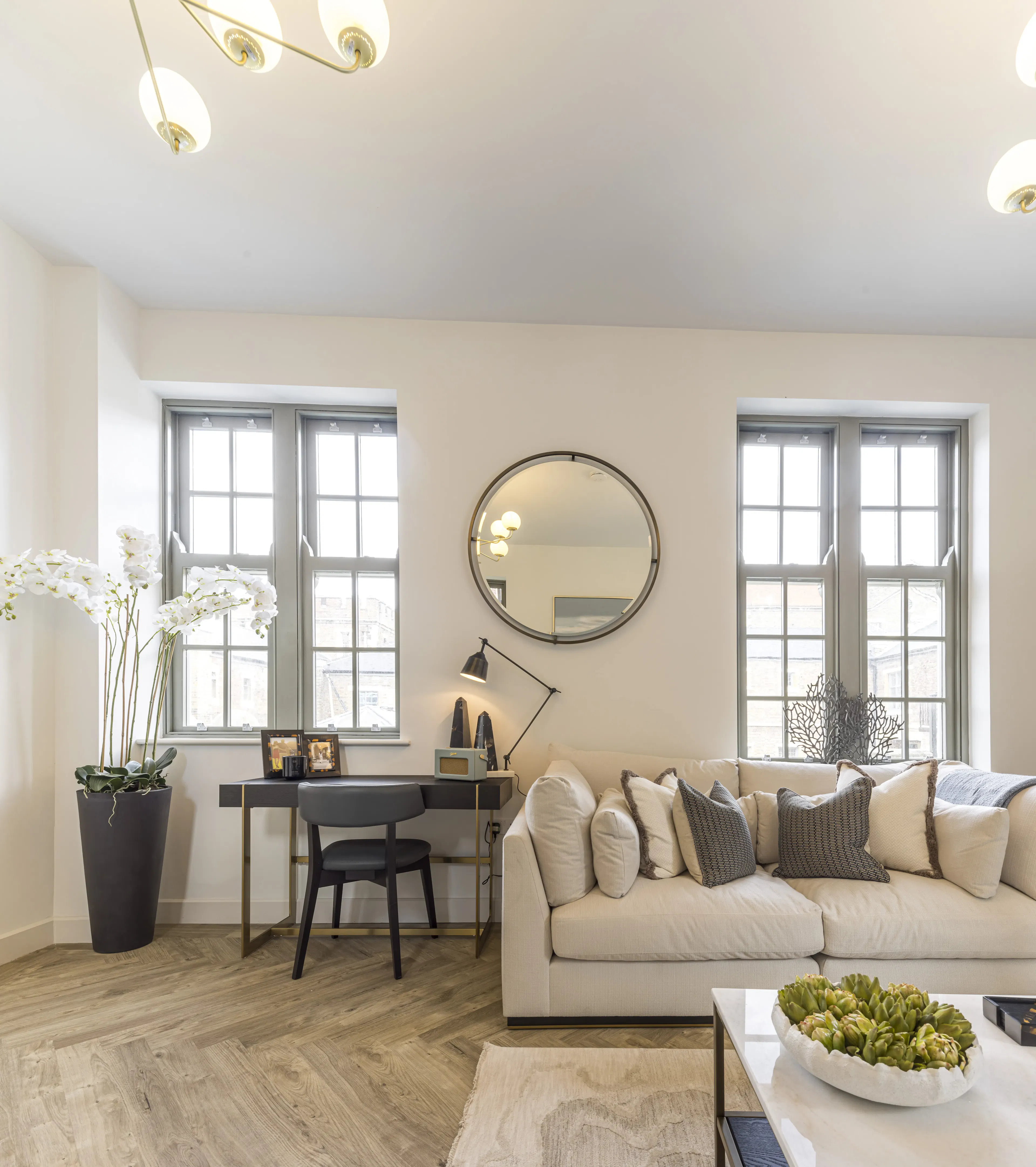 Caption: a living room filled with furniture and a table