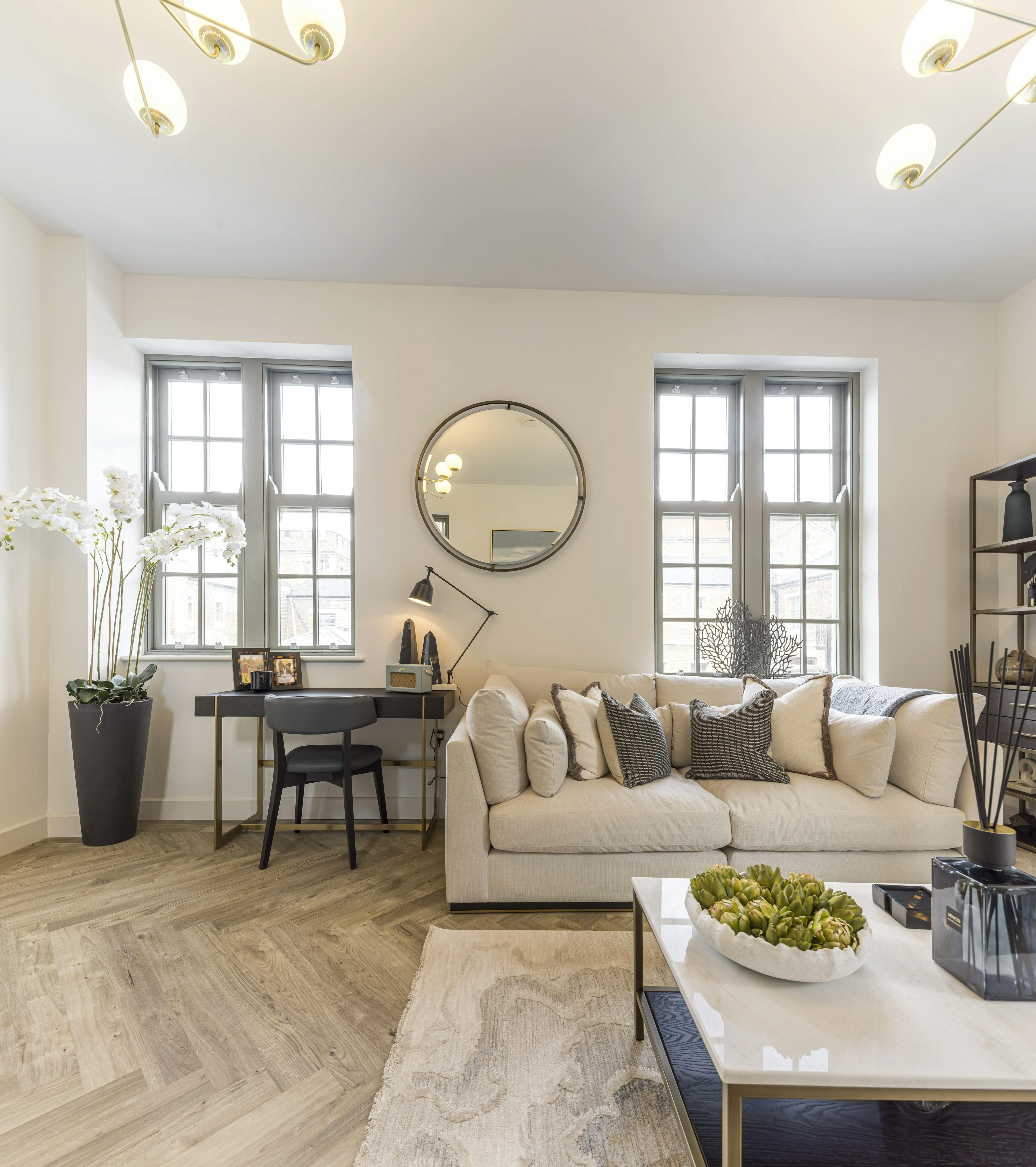 Caption: a living room filled with furniture and a table