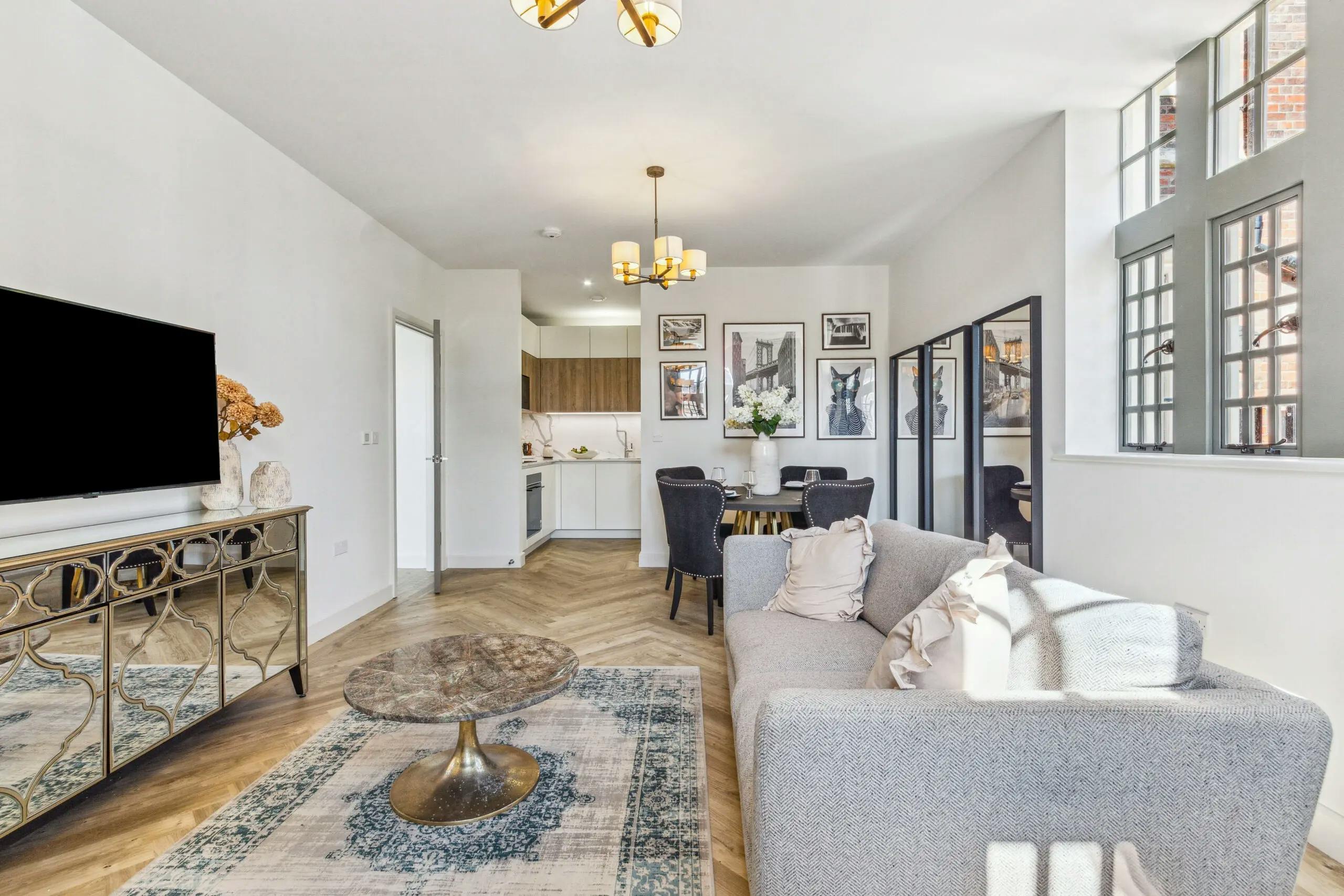 Caption: a living room filled with furniture and a flat screen tv