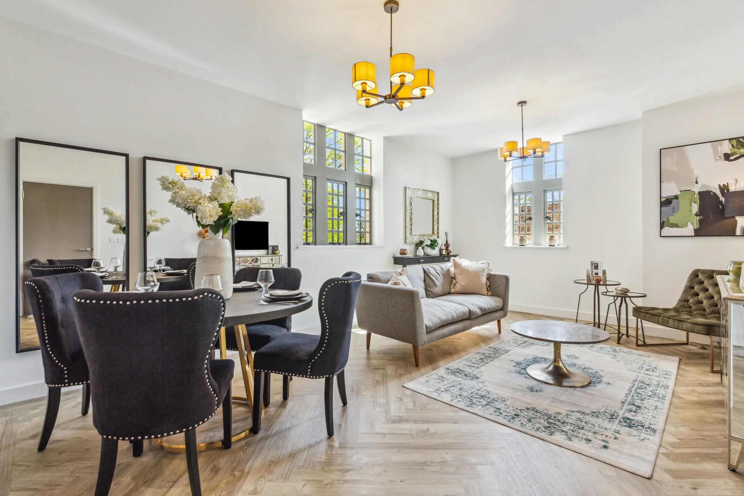 Caption: a living room filled with furniture and a dining room table