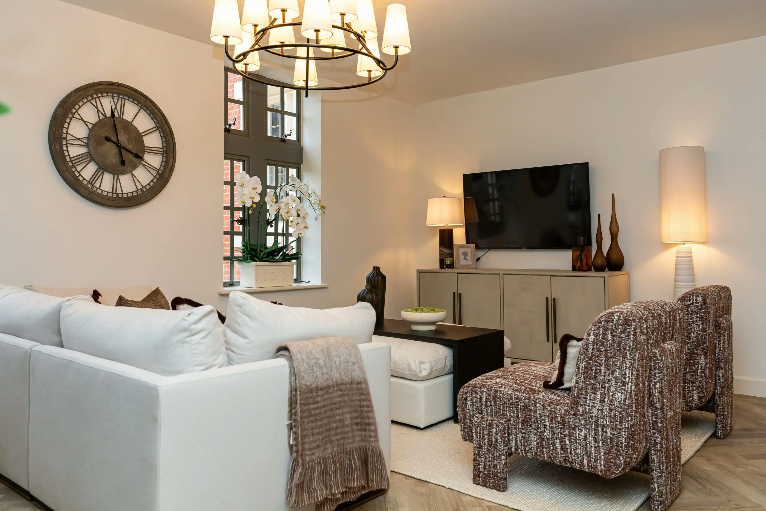 Caption: a living room filled with furniture and a flat screen tv