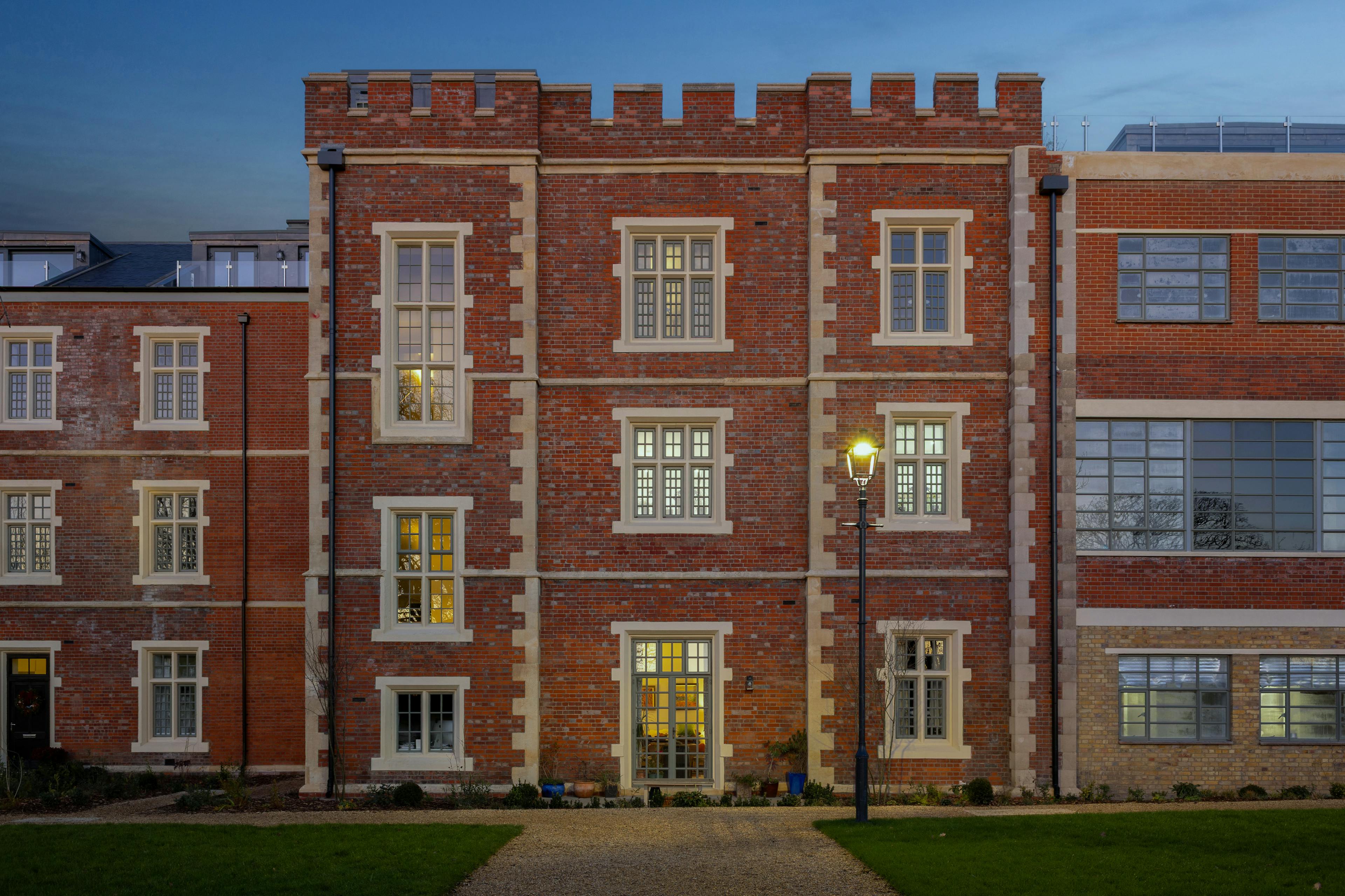 Caption: a tall brick building with windows and a street light