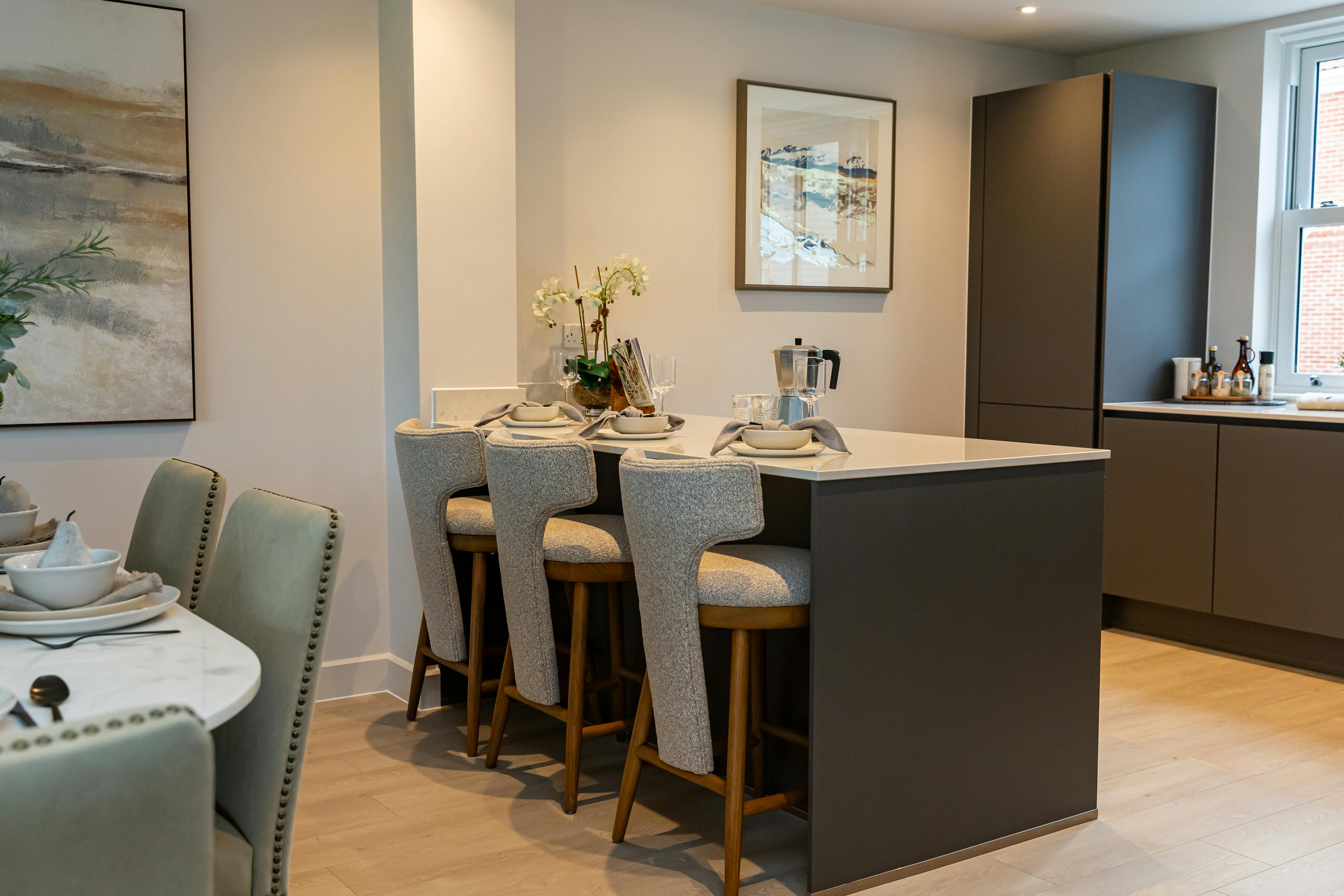 Caption: a kitchen with a center island with four stools