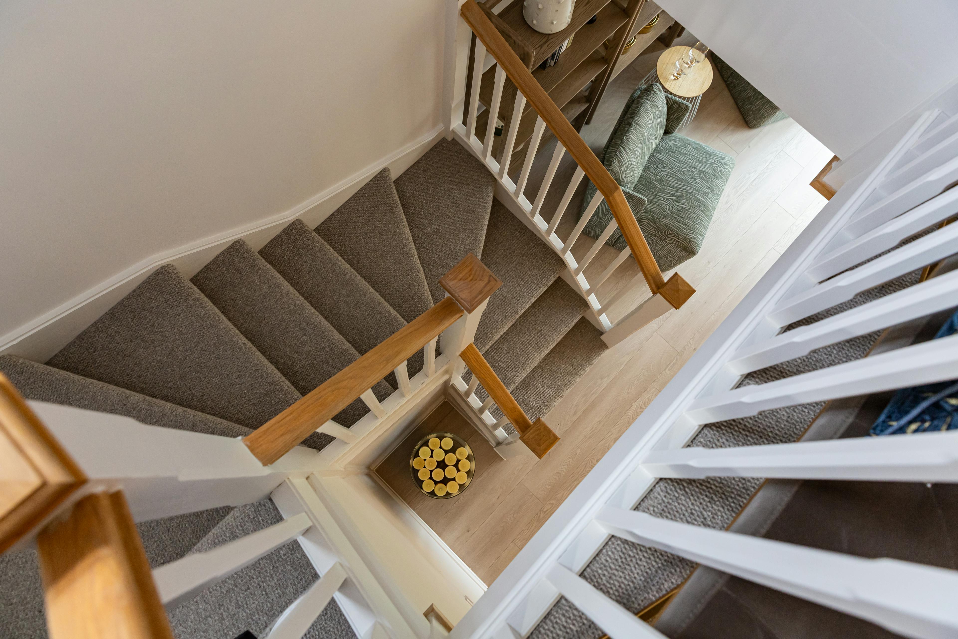 Caption: a view down the stairs of a house