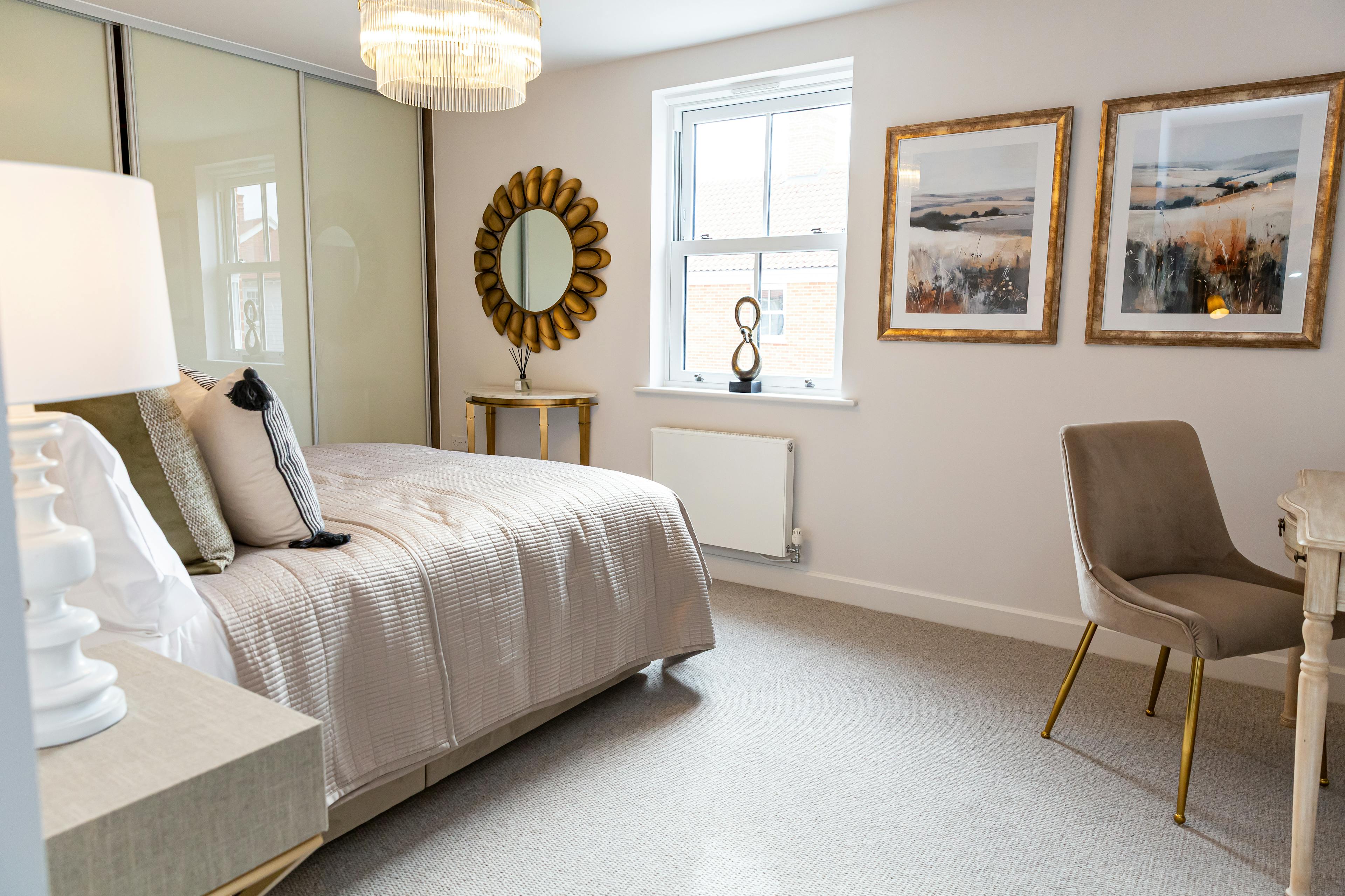 Caption: a bed room with a neatly made bed and a chair