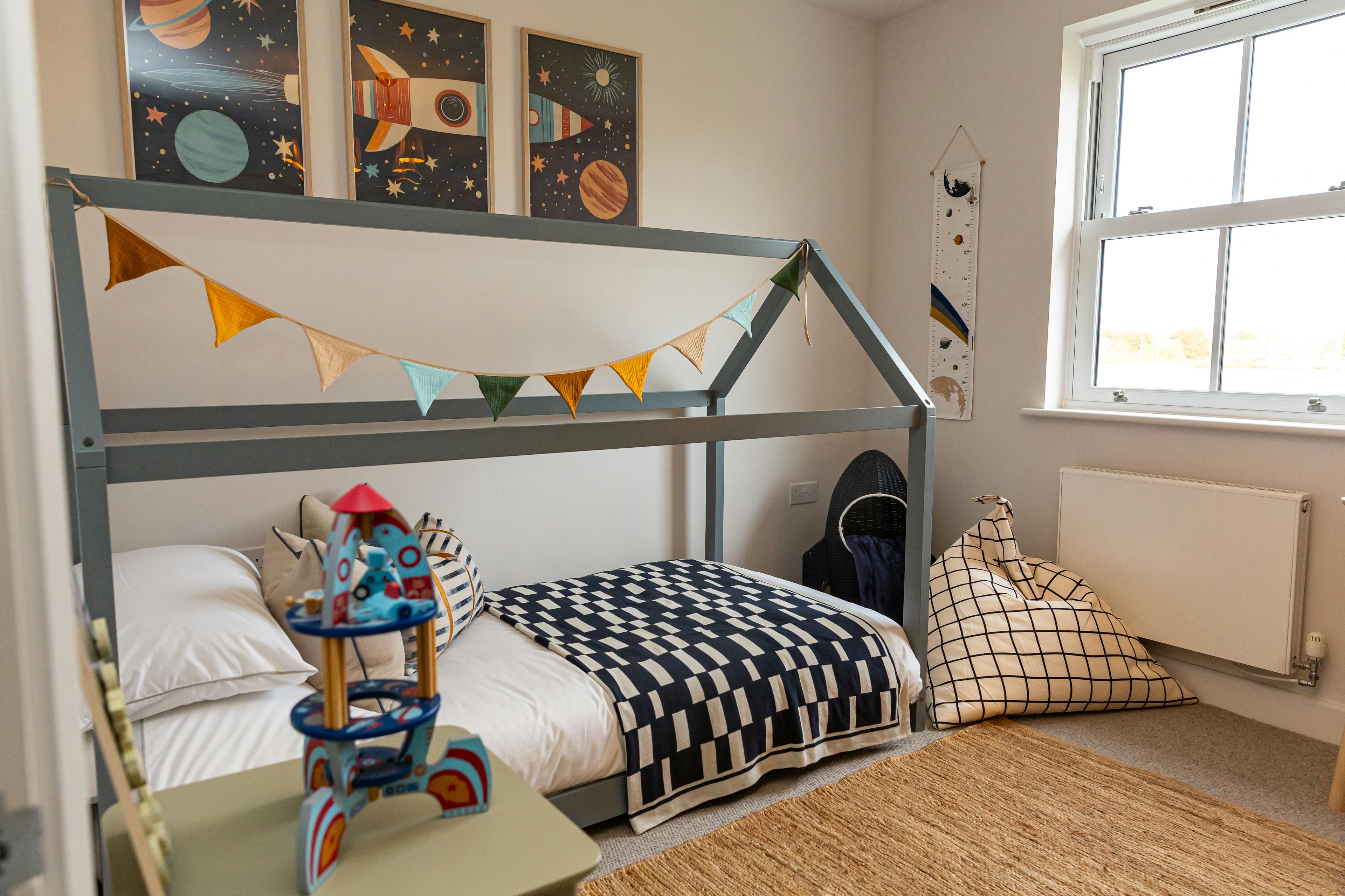 Caption: a child's bedroom with a bed and toys