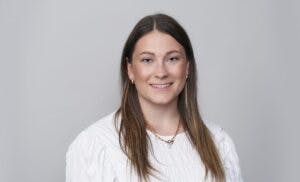 Caption: a woman in a white shirt is posing for a picture