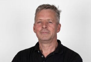 Caption: a man in a black shirt is posing for a picture