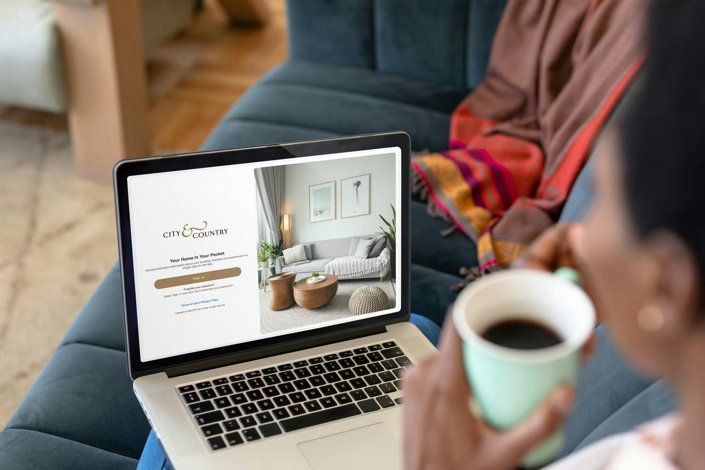 Caption: a woman holding a cup of coffee in front of a laptop