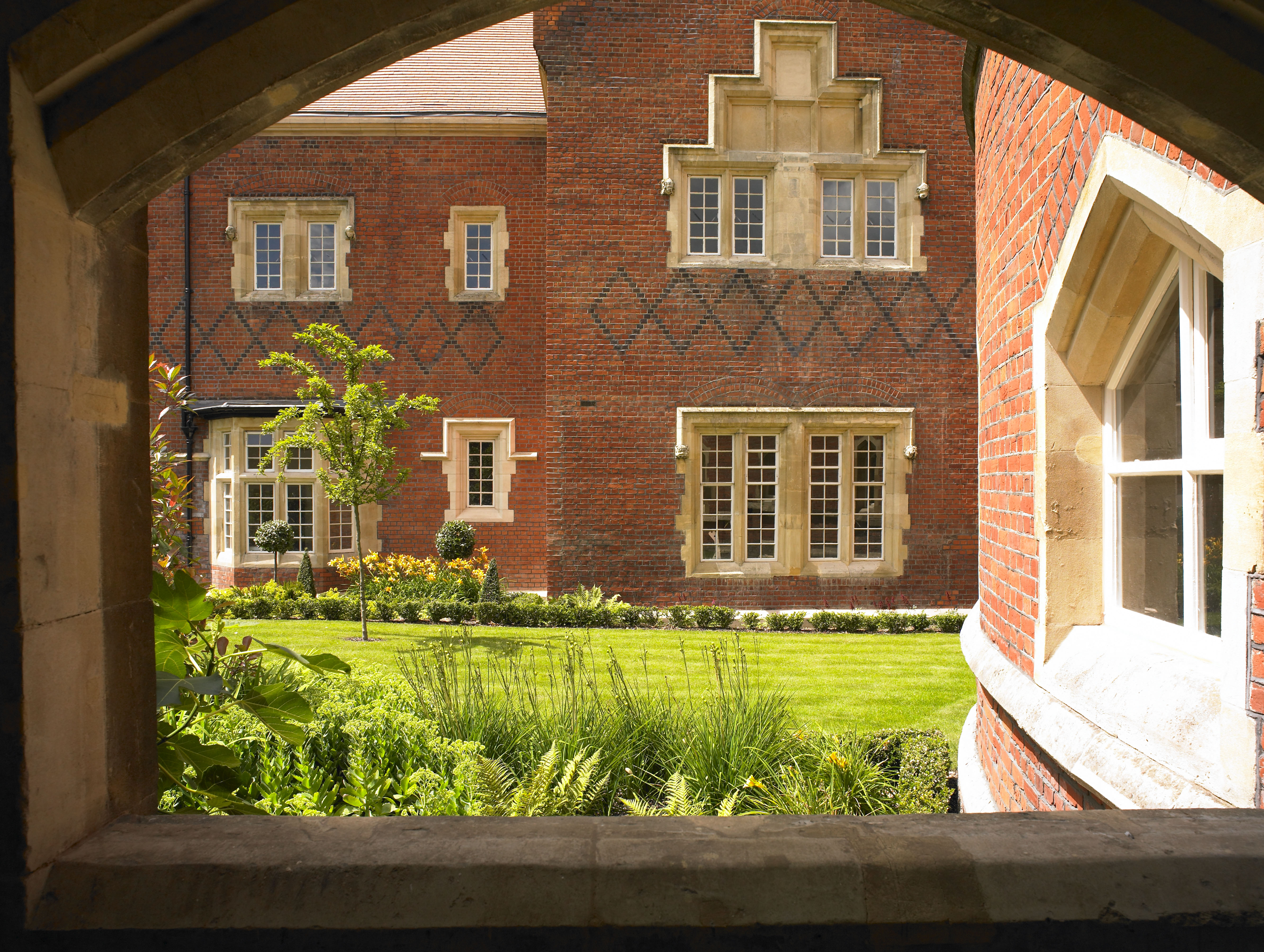 Caption: a view of a building through an archway