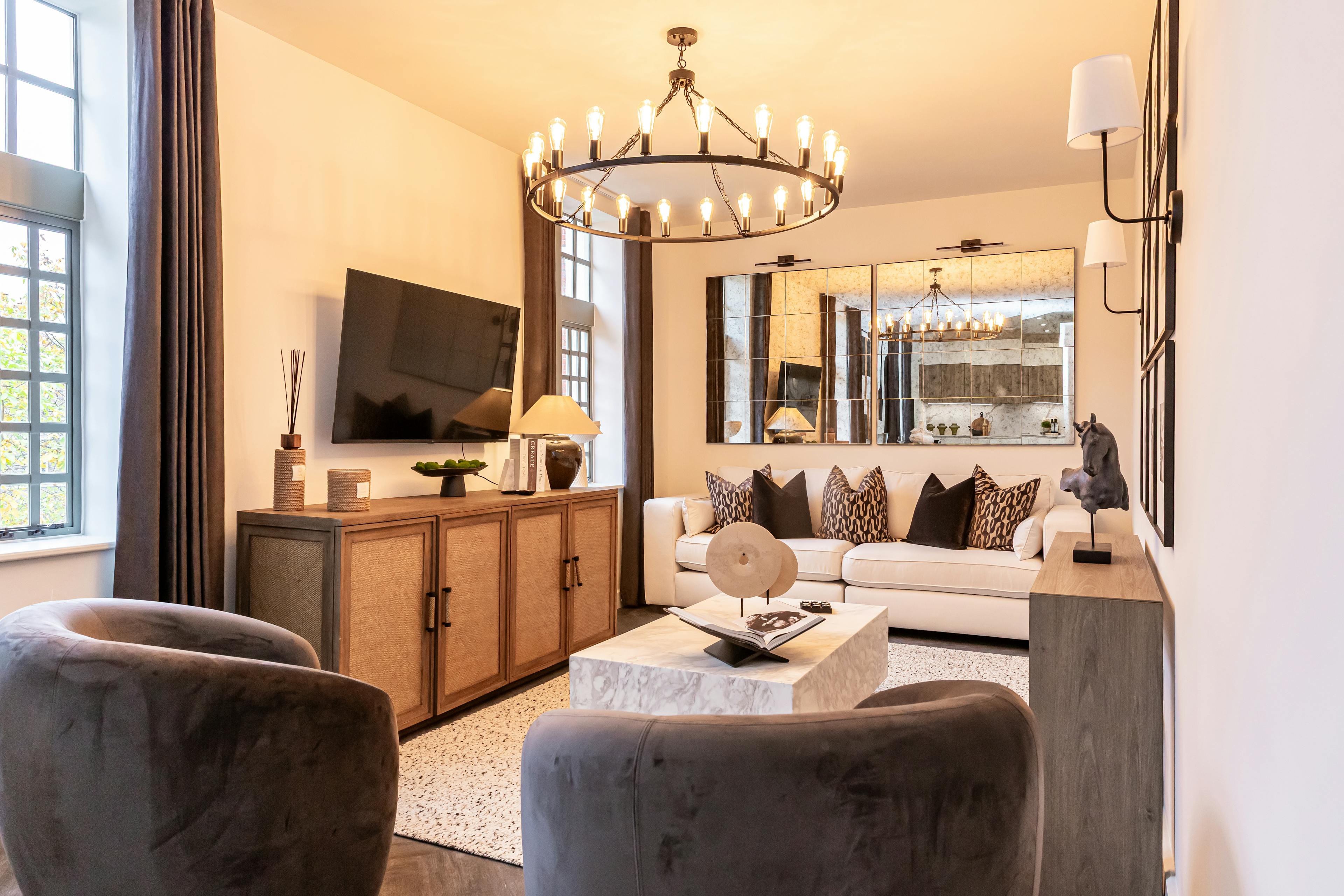 Caption: a living room filled with furniture and a flat screen tv