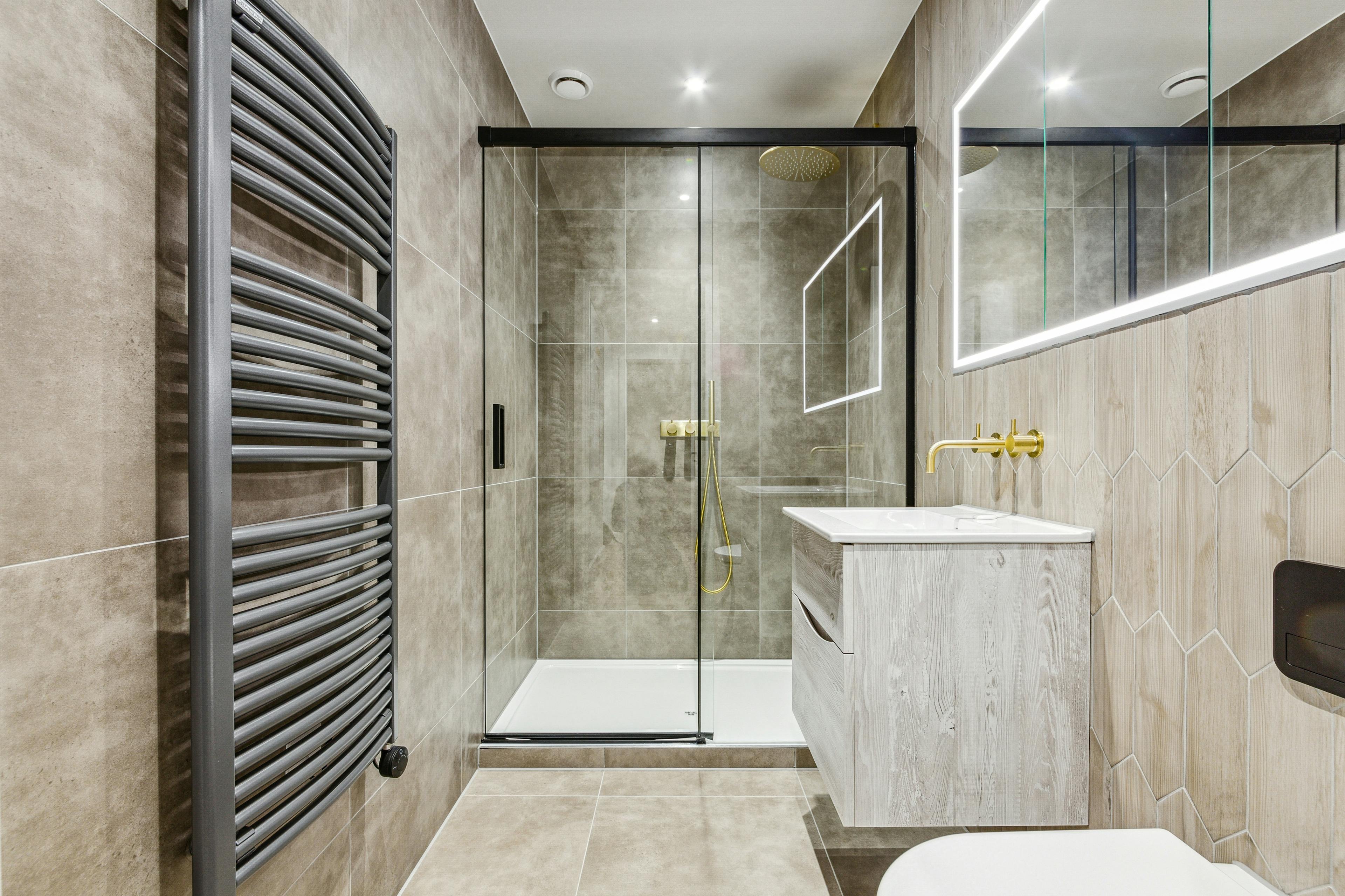 Caption: a walk in shower sitting next to a white toilet