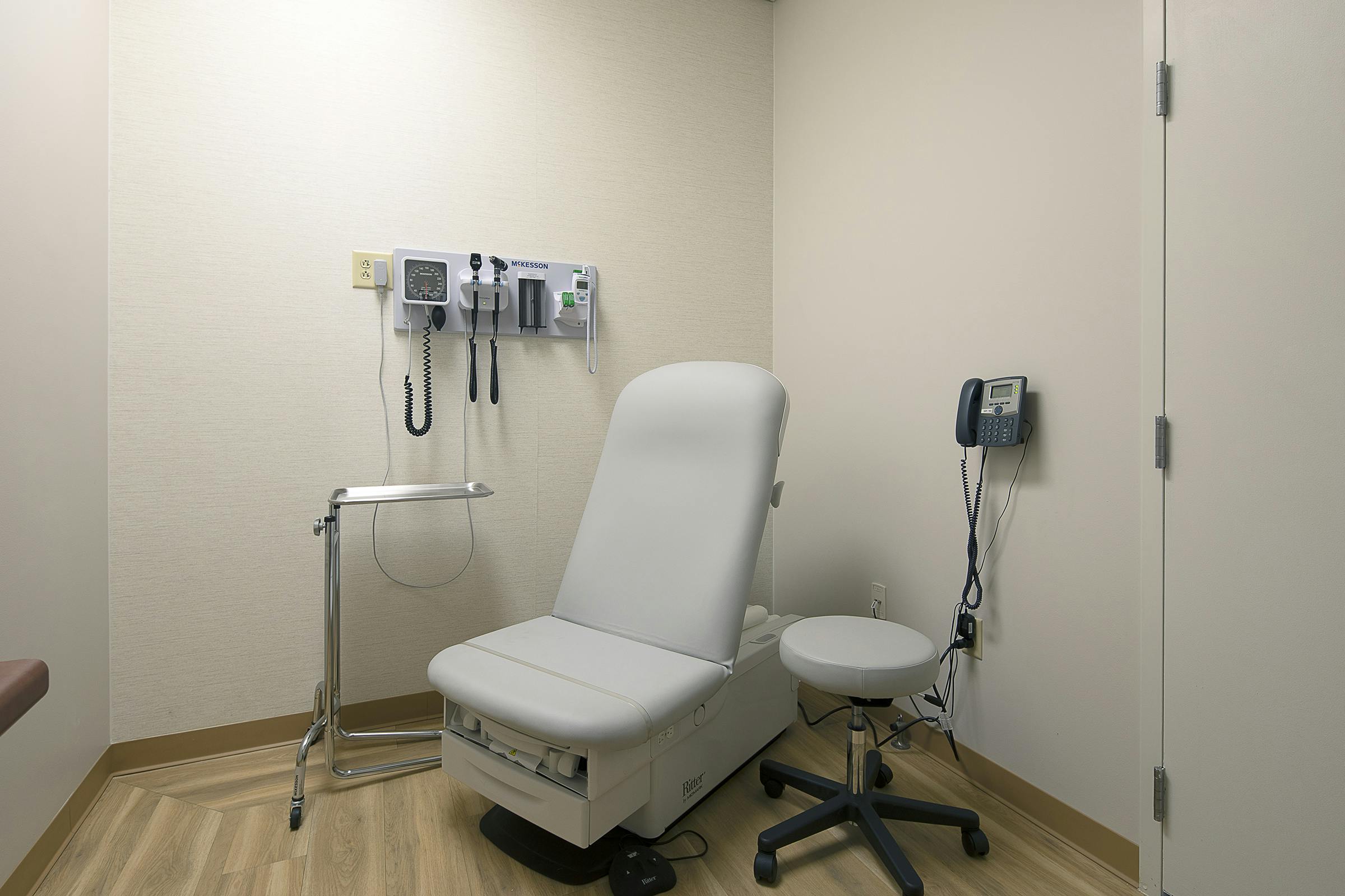 Exam room with gray chair at Cityblock Charlotte.