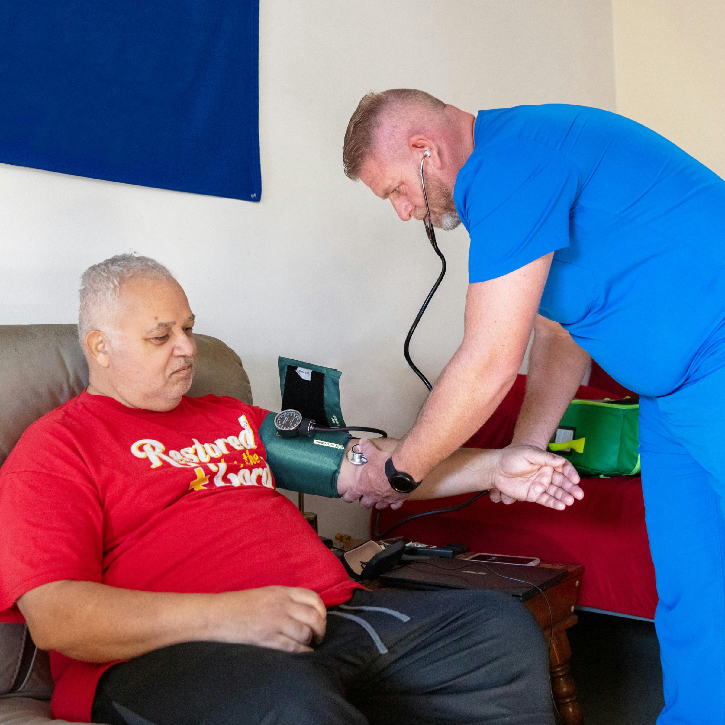Cityblock primary care team member checks blood pressure of member at home.