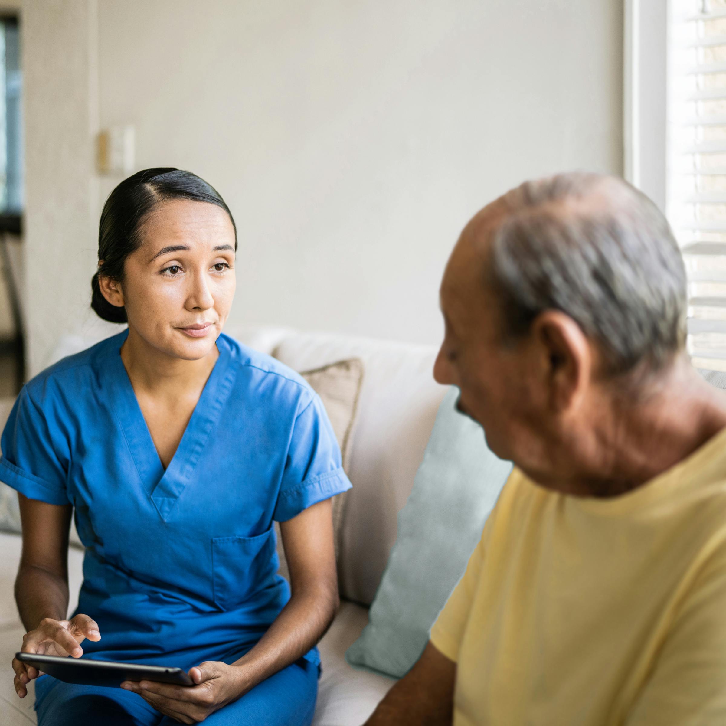 Cityblock mental health team member sits with member at home.